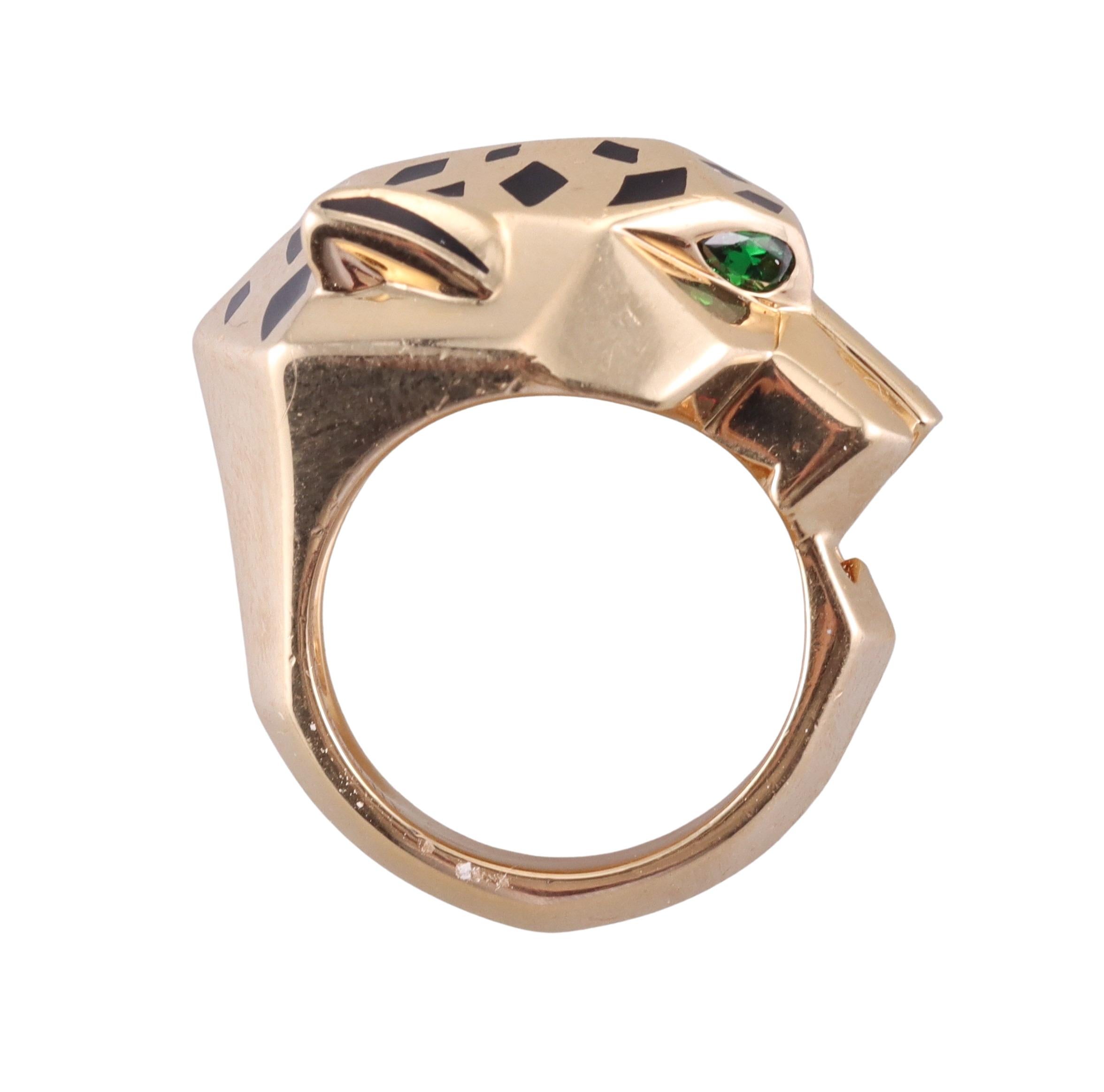 Iconic Panthere de Cartier 18k gold ring, decorated with tsavorite eyes and black enamel. Ring is a size 6.25 (Euro size 52), the top of the ring measures 0.75