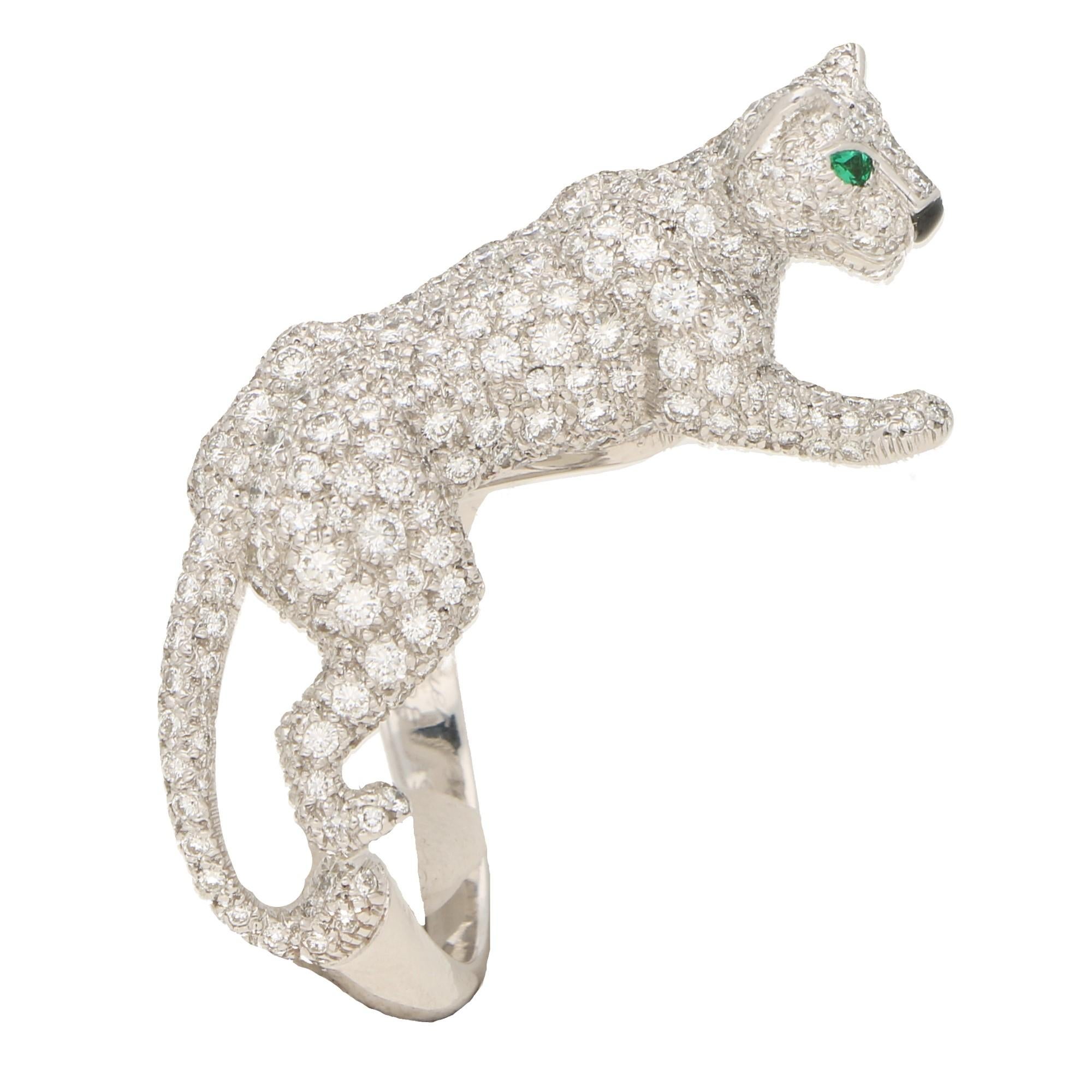 A rare Cartier diamond and green garnet walking panther ring, from the 'Panthère de Cartier' collection, set in 18 karat white gold. 

In the brand's iconic panther motif, this ring depicts a walking panther, stylized so that it appears to be