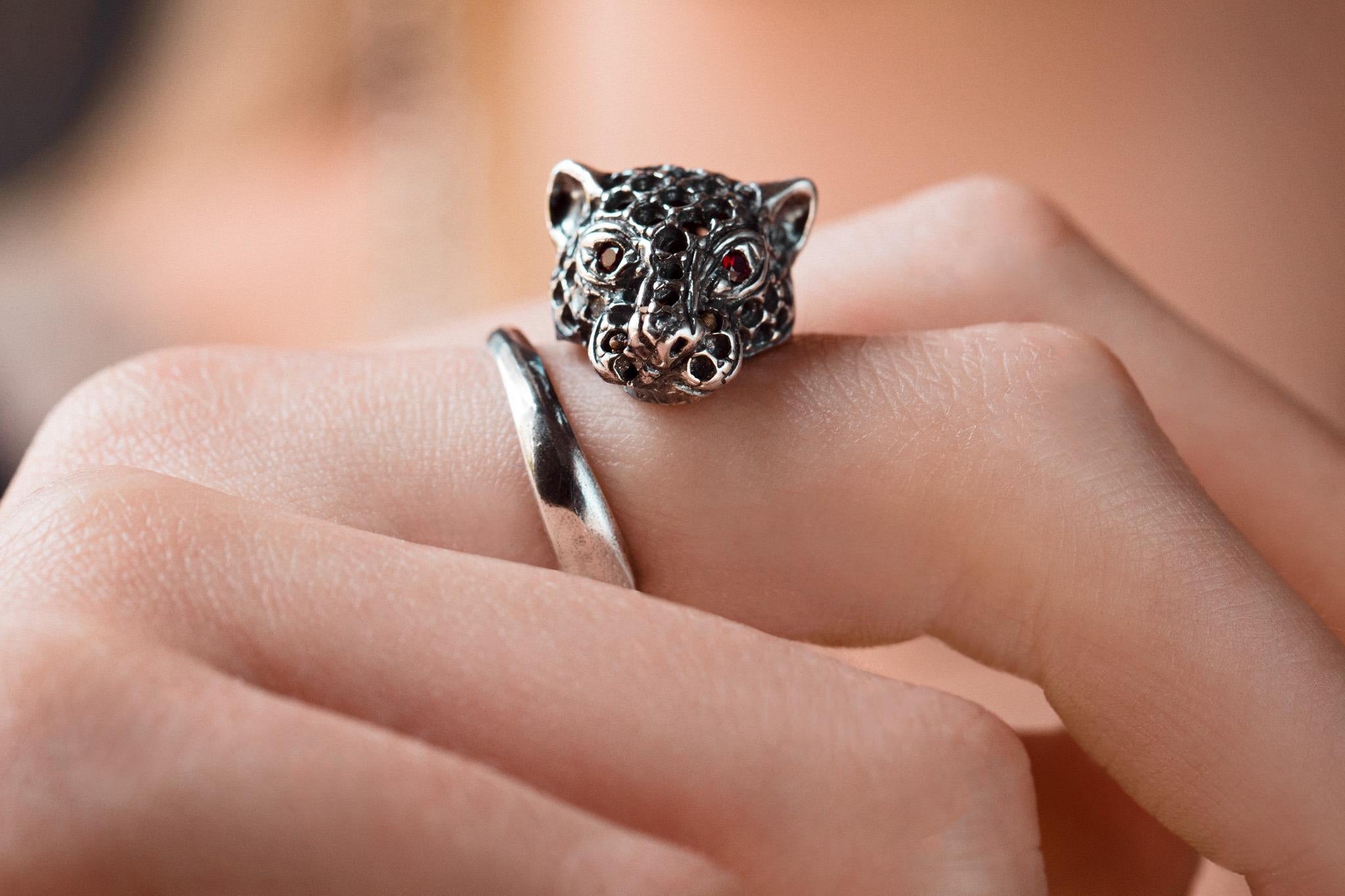 The quintessential icon of Iosselliani, the Panther's head refresh the idea of the engagement ring with its intriguing animal-inspired look. Hand crafted in antique silver, the ring is encrusted with red zircon as the panther's eyes. Wear it by