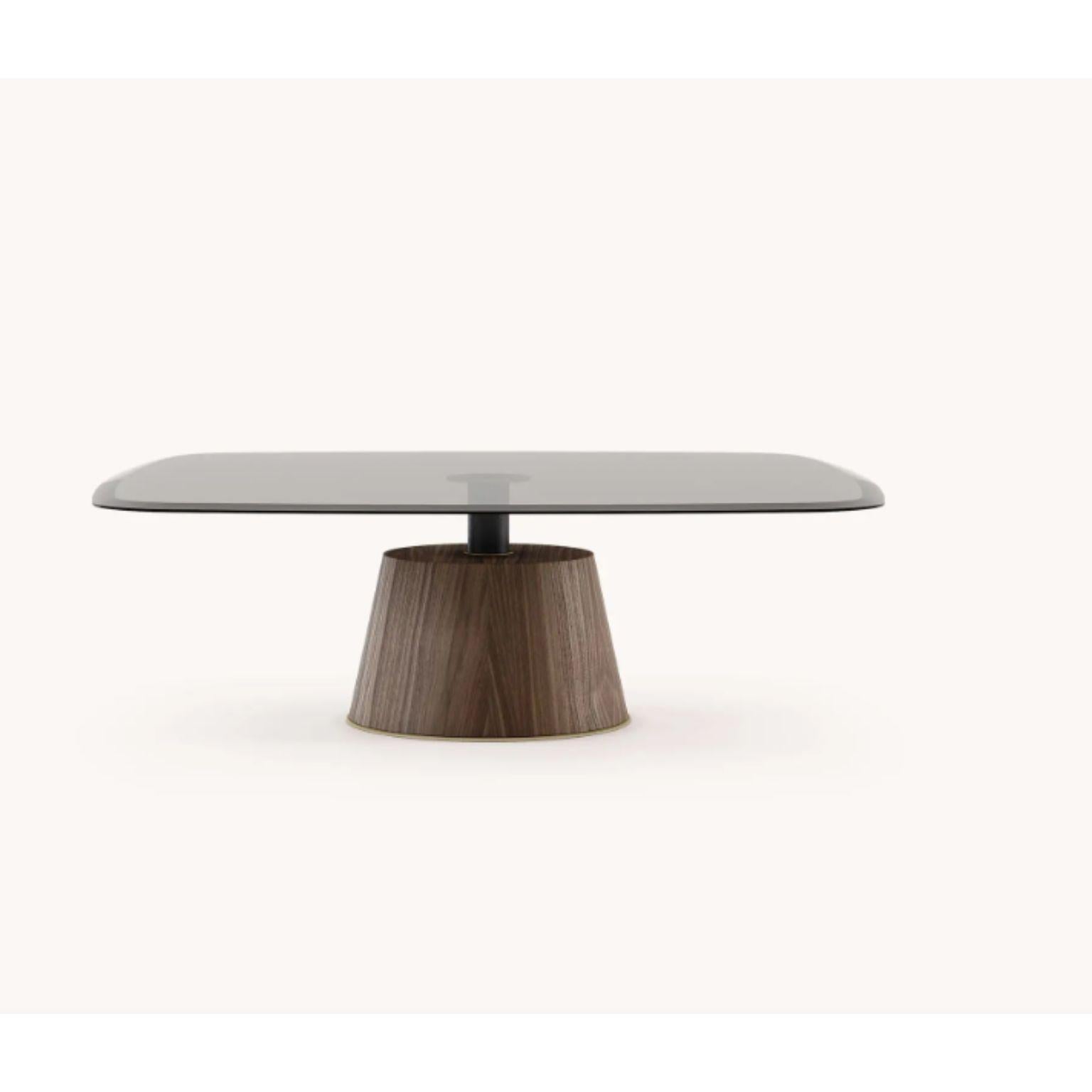 Panton center table by Domkapa
Dimensions: W 110 x D 110 x H 35 cm.
Materials: Natural walnut matte, bronze glass, black texturized steel, gold brushed stainless steel.
Also available in different materials.

Panton is a superb table with a