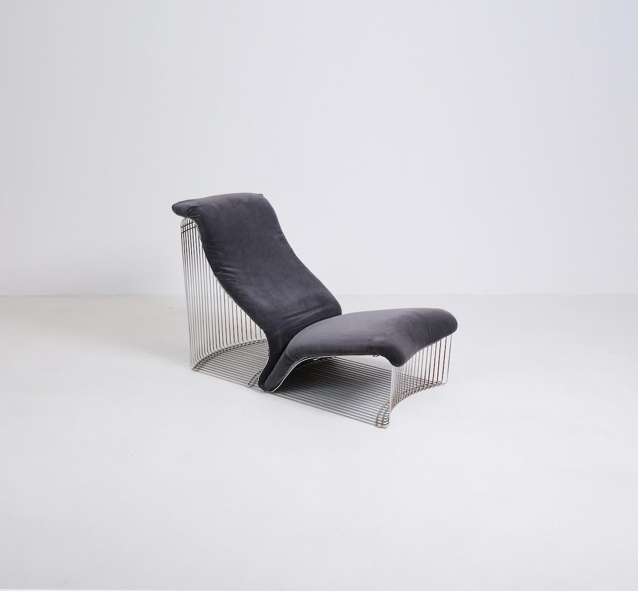 Reclining lounge chair from Vernor Panton’s wire Pantonova range produced by Fritz Hansen in the 1970s. Formed from a sculptural chrome plated wire framed and cushion upholstered in a dark grey velvet.