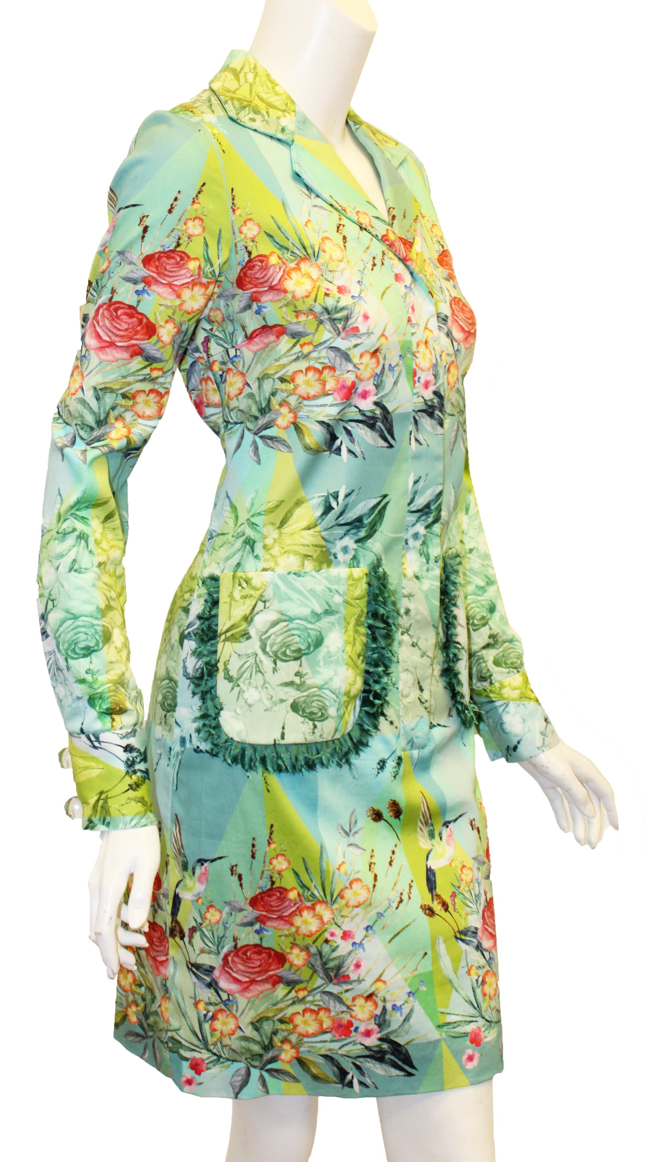 Paola Quadretti multi color cotton dress with a vibrant tropical floral inspired print is a close to the body sheath. This shirt collar dress includes two patch pockets decorated with green silk fringe.  This tropical pattern is as pleasing as a