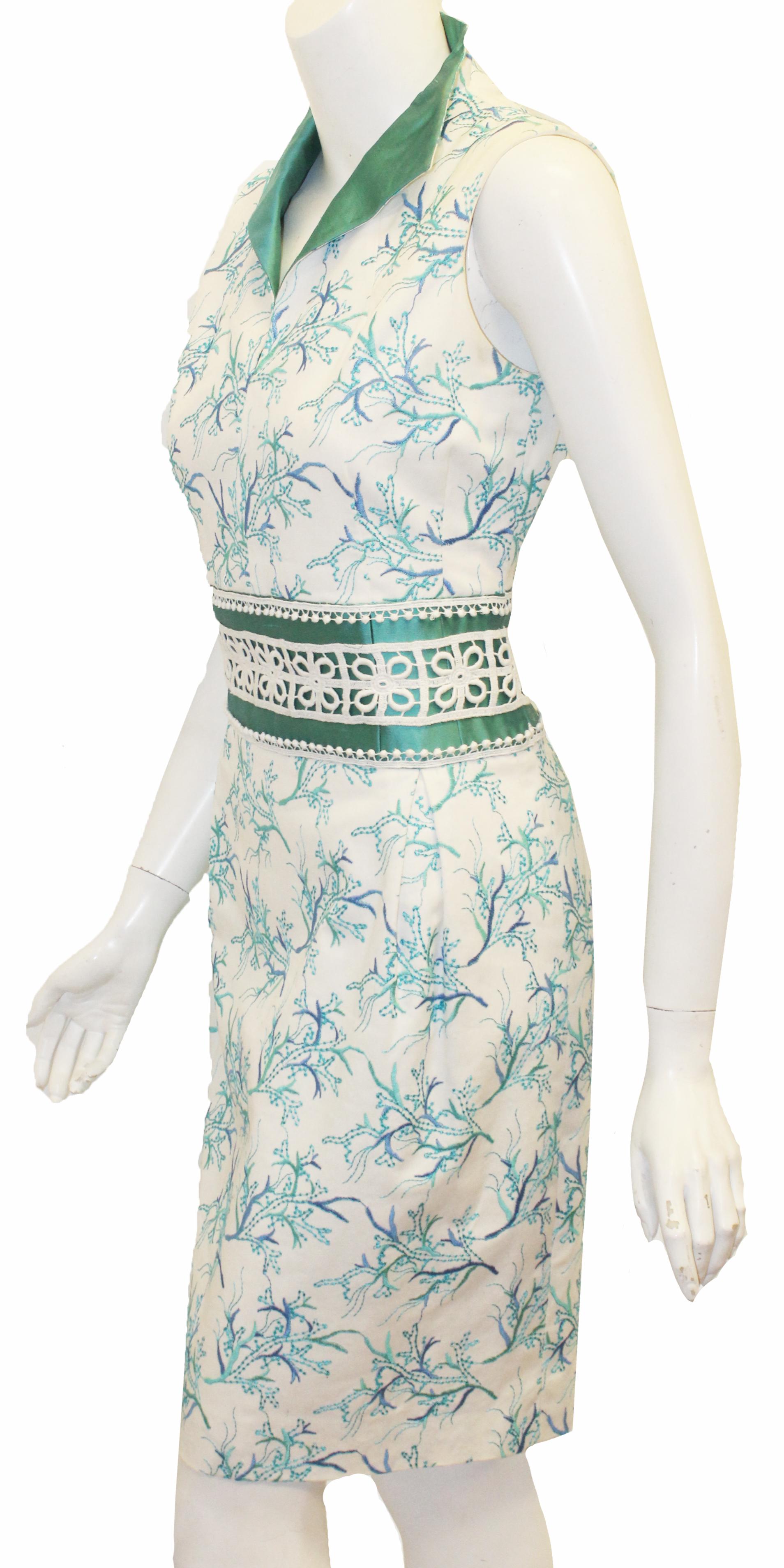 Paola Quadretti stunning white and turquoise embroidered figure flattering dress includes a waist cinching silk turquoise band enhanced with white cotton crochet lace.  The same turquoise silk fabric on the waist is used on the turn up collar.  With
