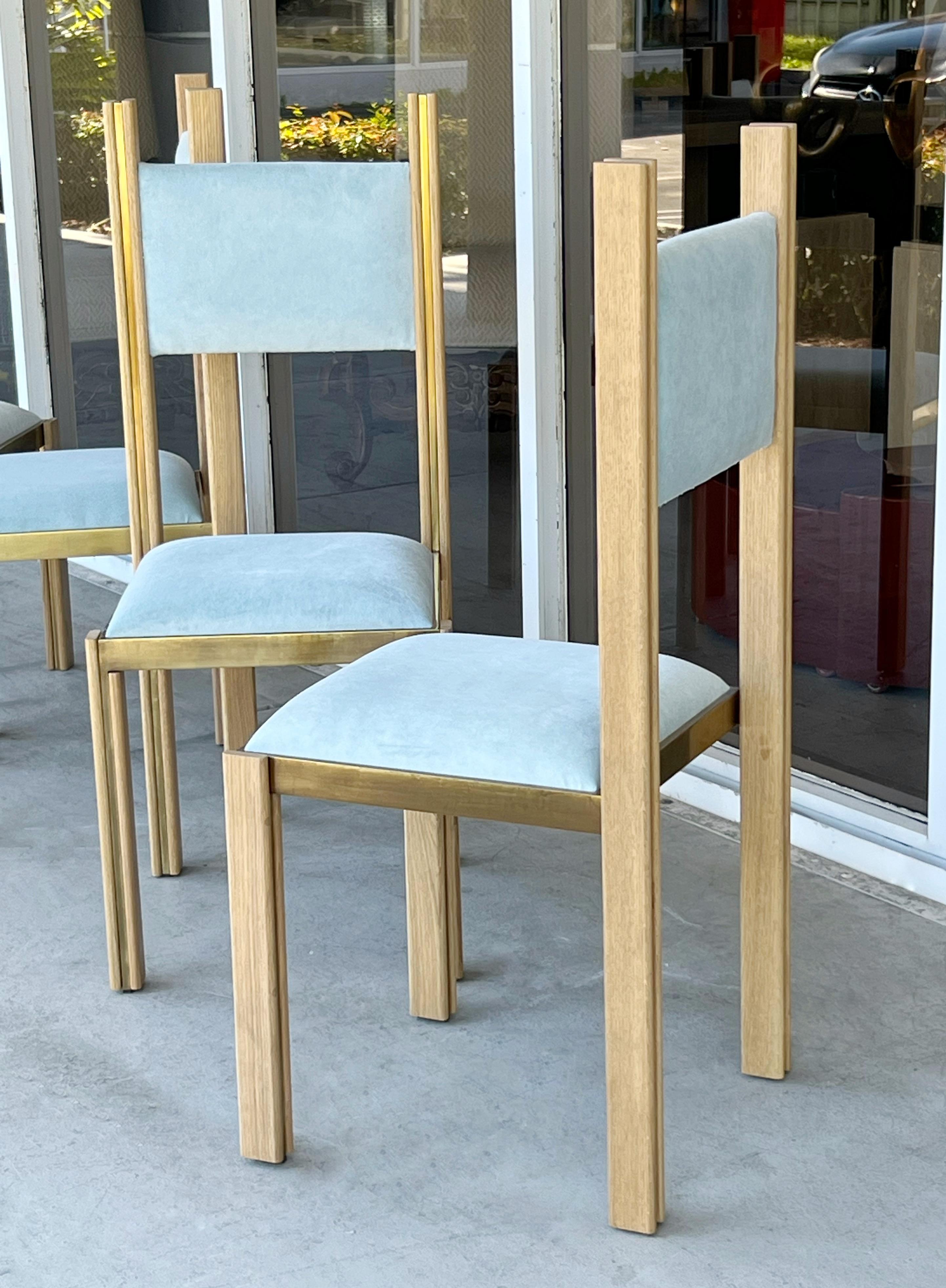 A set of 8 brass and oak dining chairs by Paolo Barracchia. 