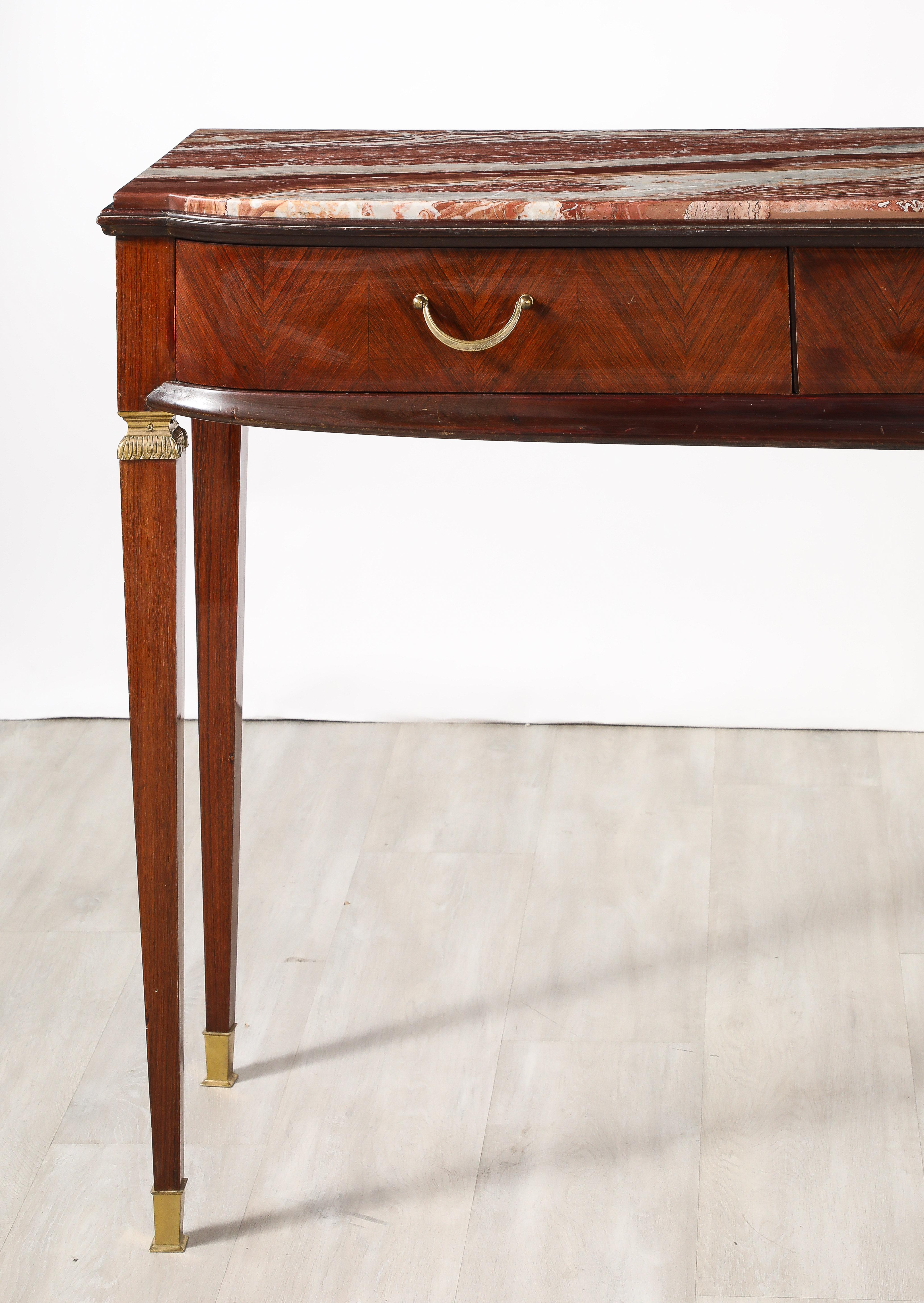 An elegantly appointed Italian mahogany console table by designer Paolo Buffa; the spectacular shaped marble top rests on a gently curved apron comprising three drawers with delicate brass handles, atop graceful square tapered legs with brass