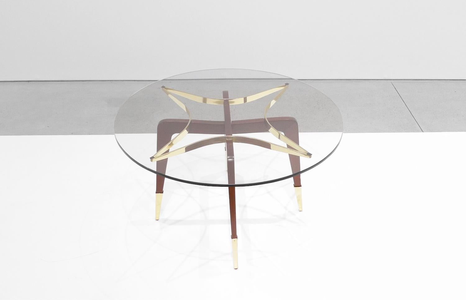 Paolo Buffa coffee table with brass star frame feature that supports circular glass top. Long decorative brass feet.
Italy, circa 1950s

Meticulously restored and in excellent condition.

