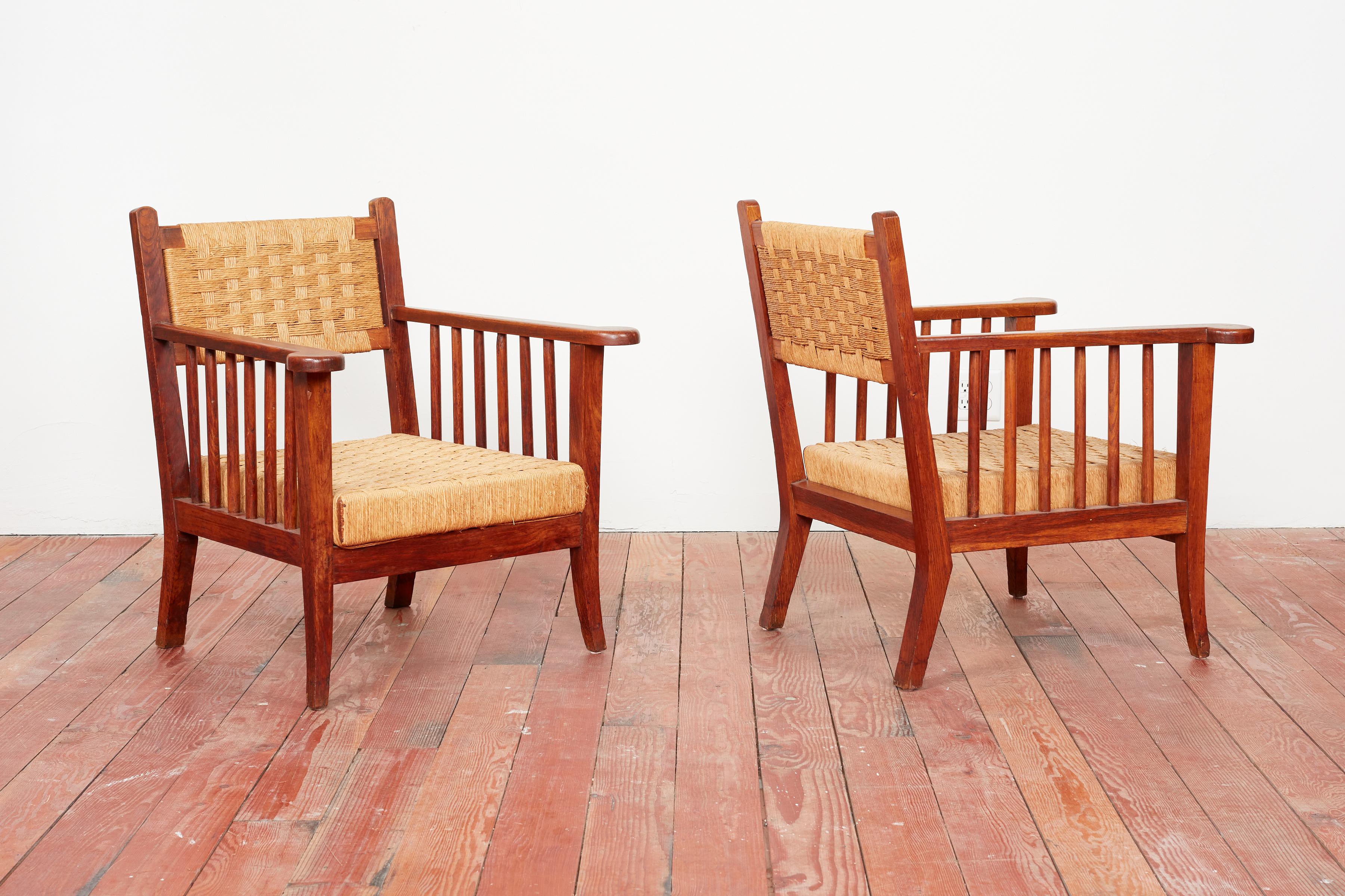 Pair of woven chairs attributed to Paolo Buffa - Italy, 1940s 
Great angular shaped wood frame and legs with original straw seat and back. 
Spindle wood sides with curved arms. 
Great Pair!