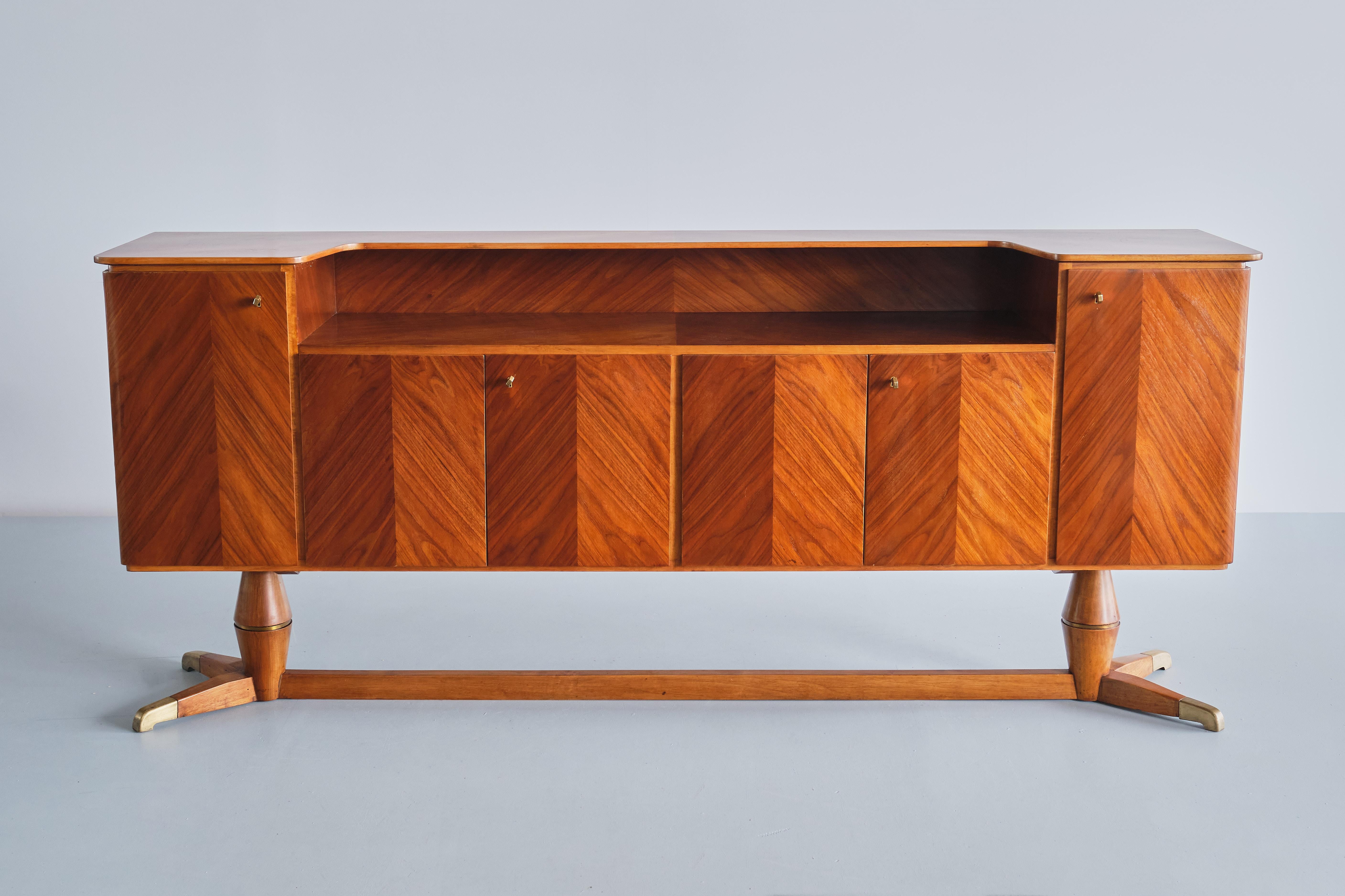This exceptional sideboard was produced by the company Serafino Arrighi in Cantù, Italy in the late 1940s. The design is attributed to Paolo Buffa, who worked with Serafino Arrighi for the execution of many of his designs in this era. 
The design