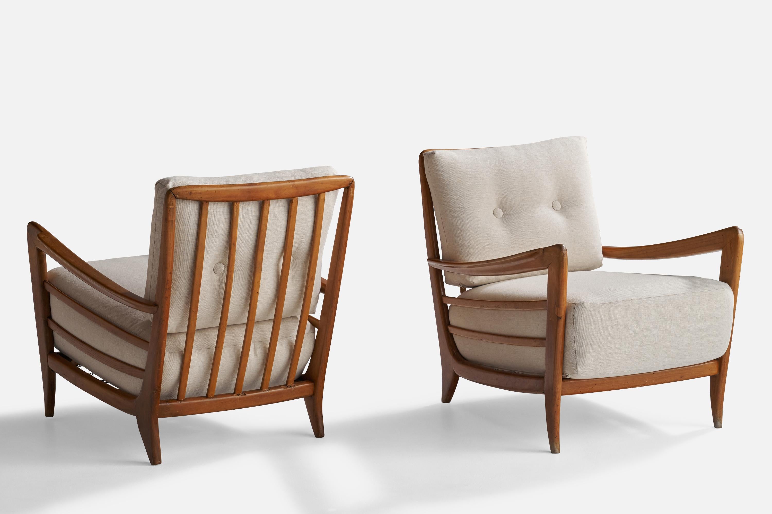 A pair of walnut and white fabric lounge chairs; design and production attributed to Paolo Buffa, Italy, 1940s.

Seat height 16.5