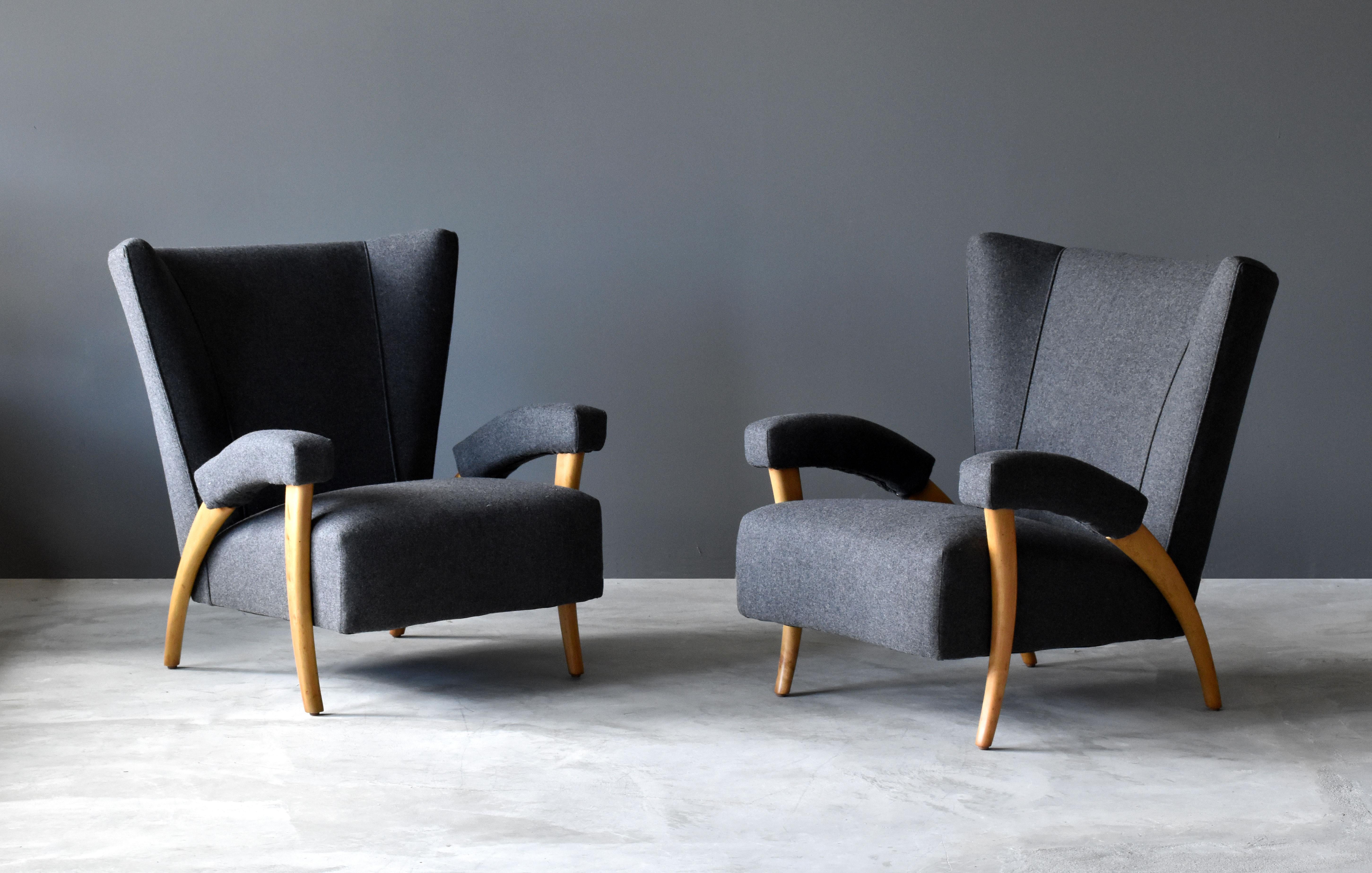 A pair of early and organic modernist lounge chairs or armchairs. Design attributed to Paolo Buffa.

The brand new European high-end fabric contrasts the lightly restored light oak. Construction of chair includes spring seats and spring-padded