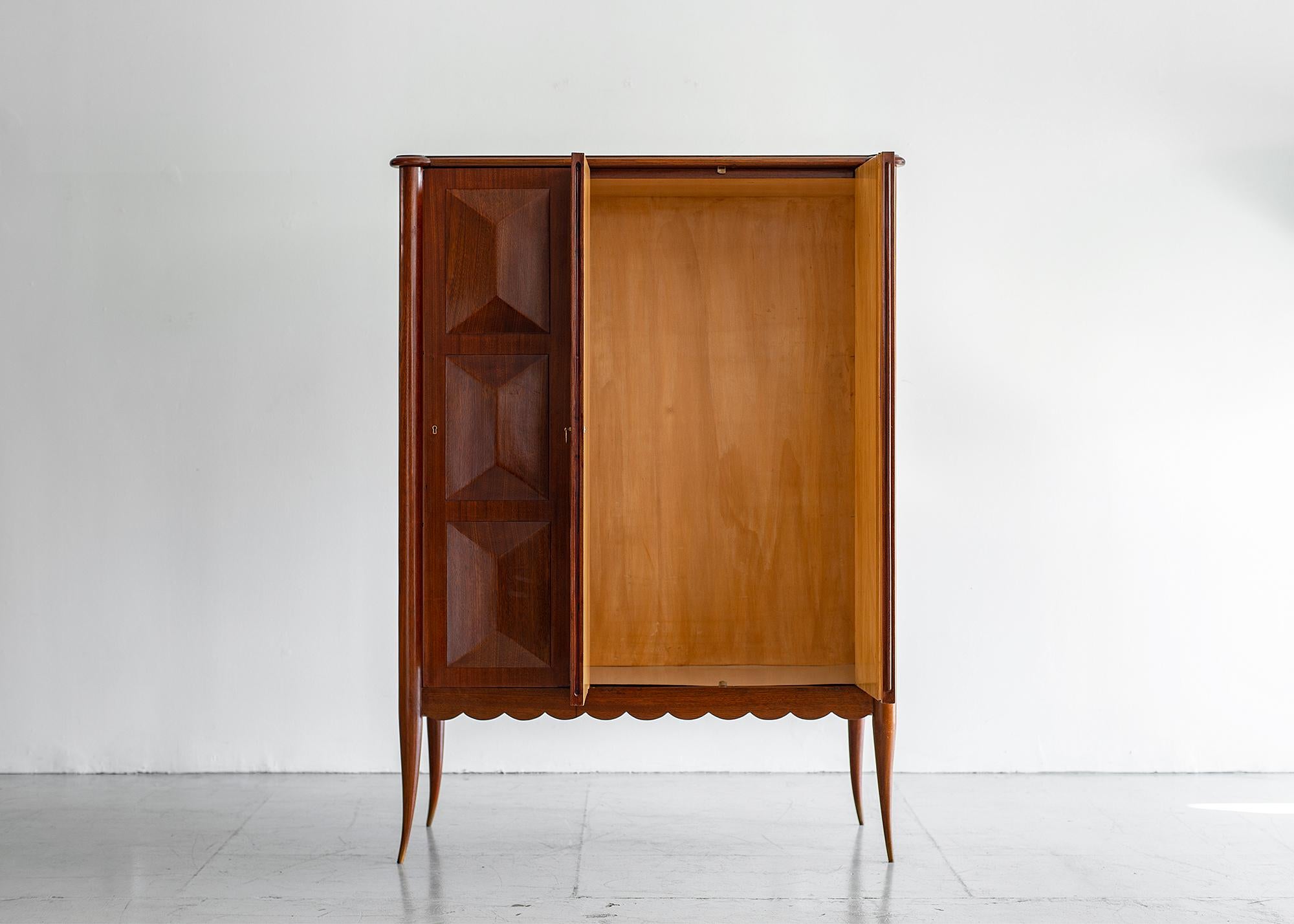 Gorgeous Paolo Buffa cabinet, circa 1940s.
Rare 1940s cabinet with scalloped edge detail and horn legs.
Cabinet opens with 2 doors -revealing beautiful wood inside.
Shelves can be any height.
Mahogany wood with original finish.