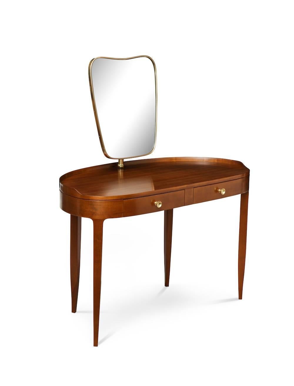 Rare dressing table by Paolo Buffa. Sexy two-drawer table in cherrywood. Lozenge-shaped top, with gallery edge and tapering legs. Brass circular pulls and brass mount for mirror which pivots forward and back. An outstanding example of Buffa's design