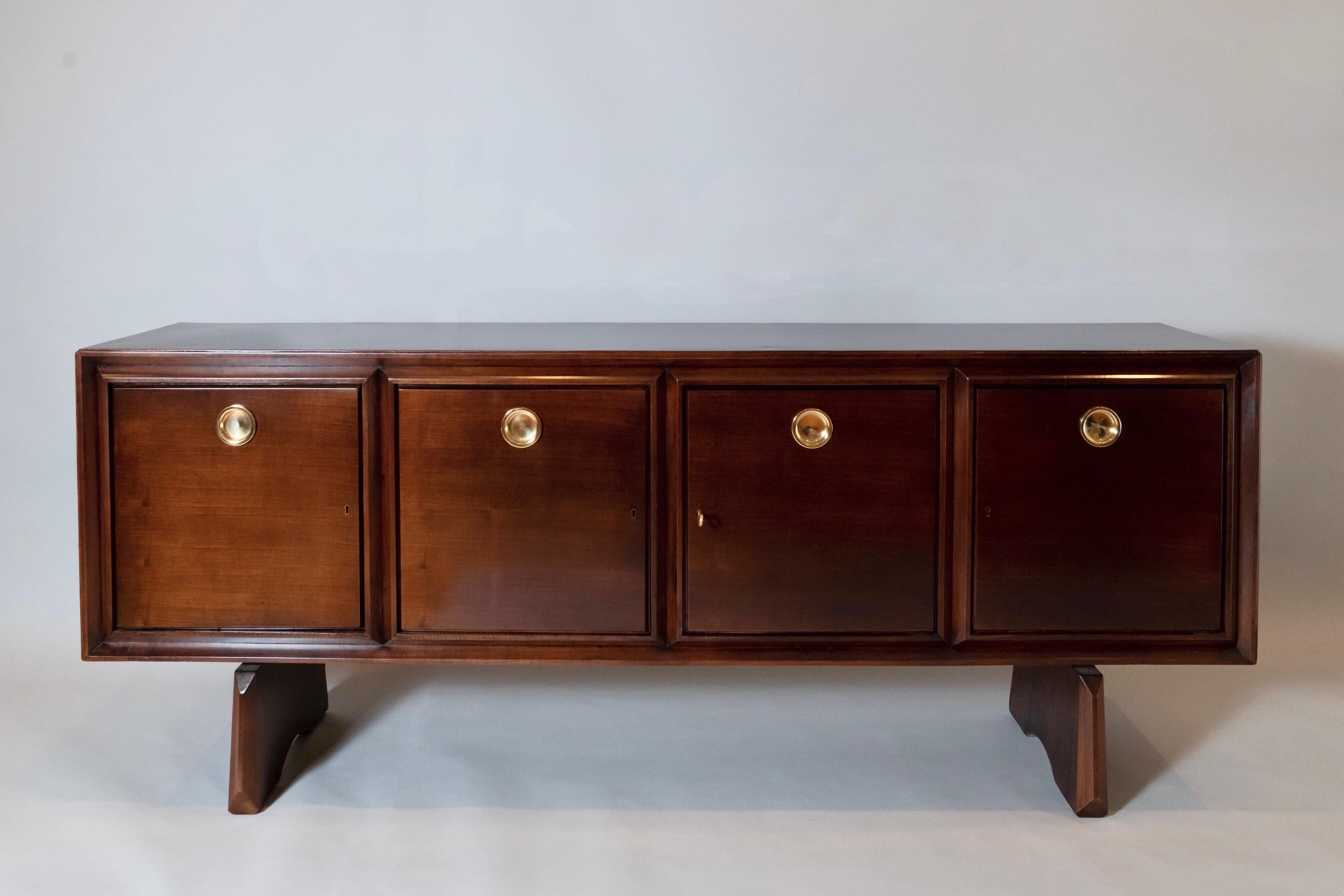 Paolo Buffa (1903 - 1970) 

A large and imposing sideboard by Milanese architect and designer Paolo Buffa, in walnut with round mirror-polished brass handles. The buffet's long, rectilinear body is incised with a sculpted, haut-relief double frame