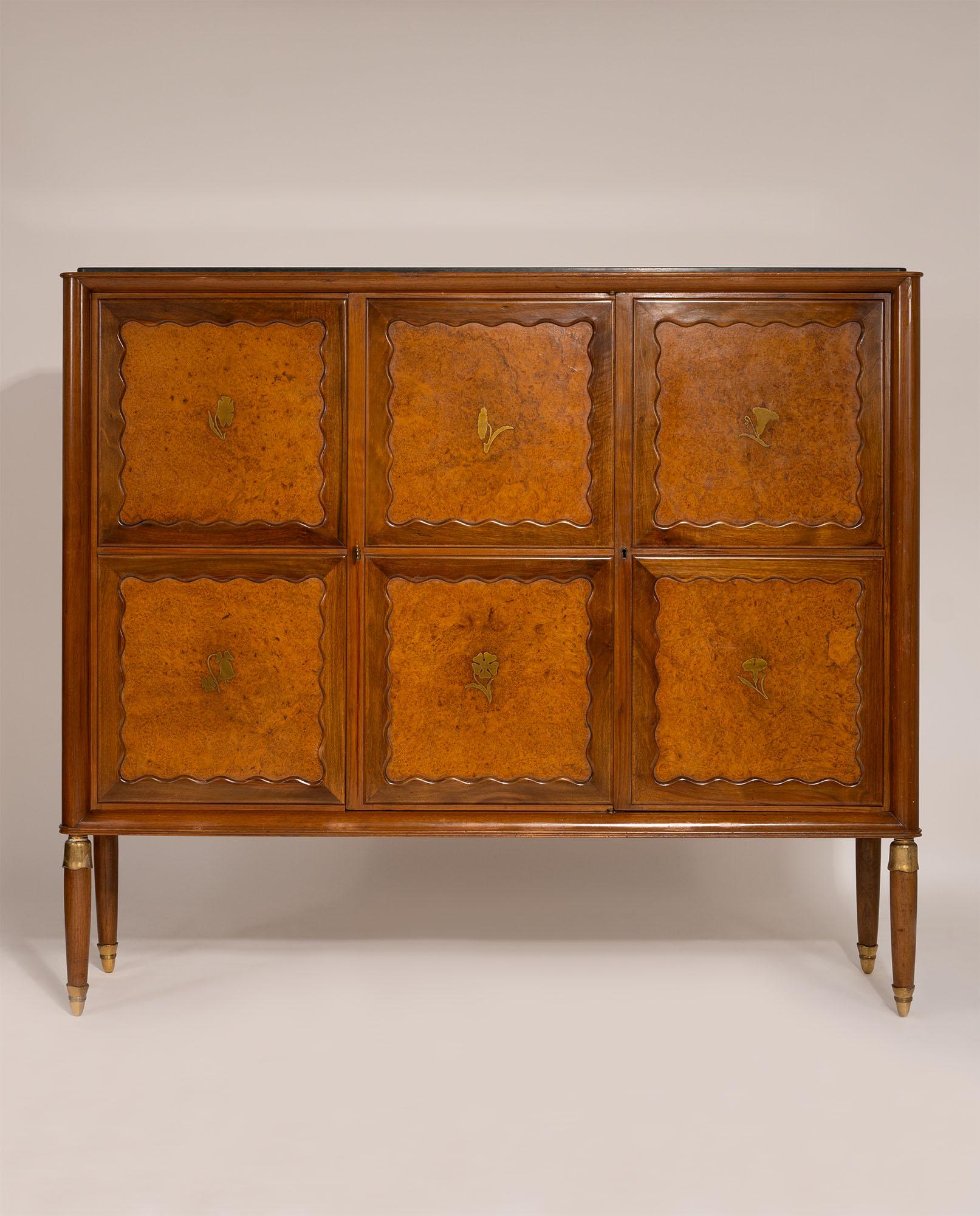 Highboard designed by Paolo Buffa, Italy, 1956. The piece features a green Alpine marble top resting on a case in walnut wood and birch burl, creating a refined contrast of materials and tones. The cabinet doors are decorated with brass floral