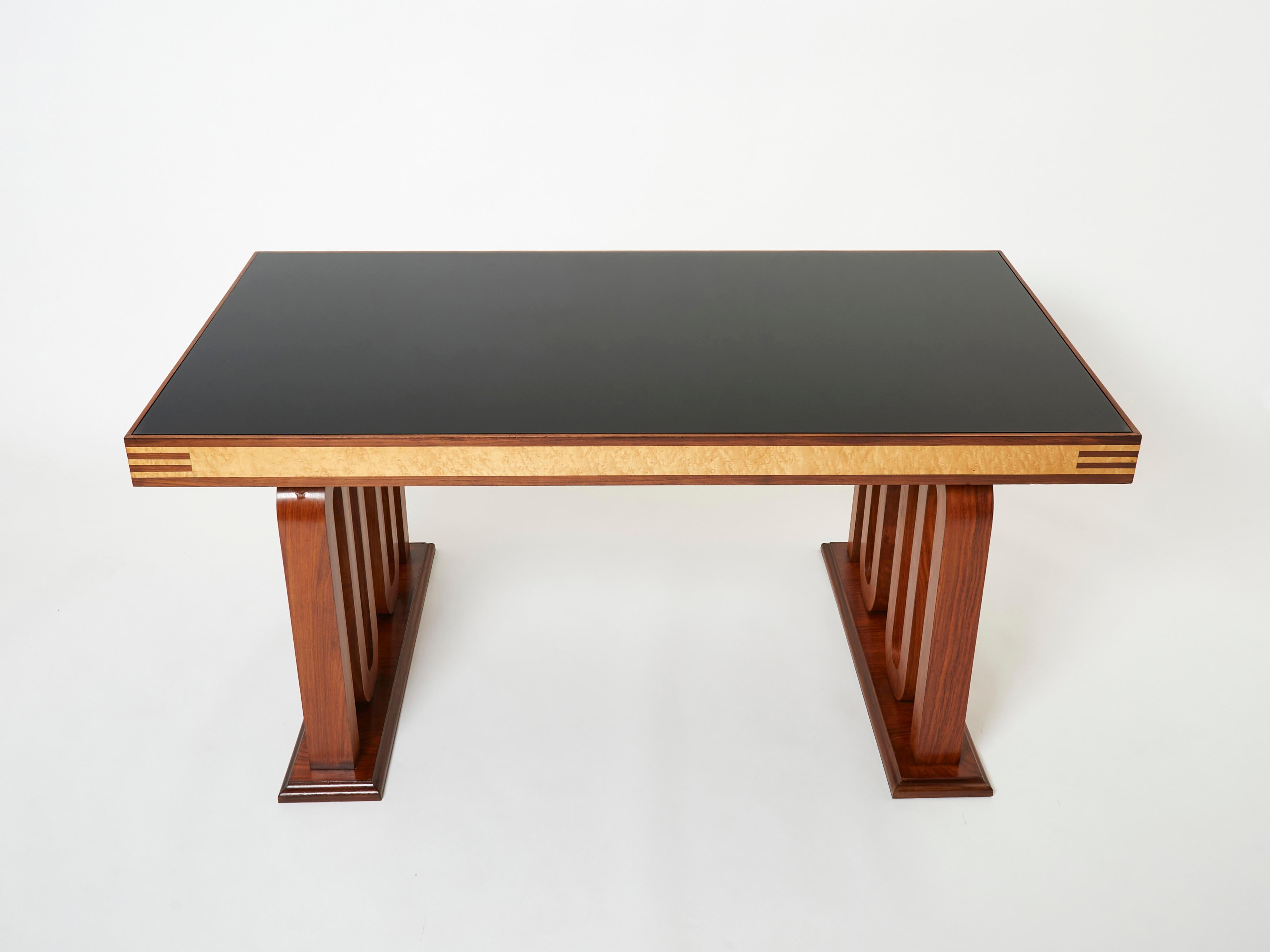 This beautiful desk table or dining table was designed by Paolo Buffa in Italy in the 1940s. The warm mix of rosewood and birdseye maple remains looking healthy and smooth eighty plus years later. The waving shaped feet is really a beautiful work.
