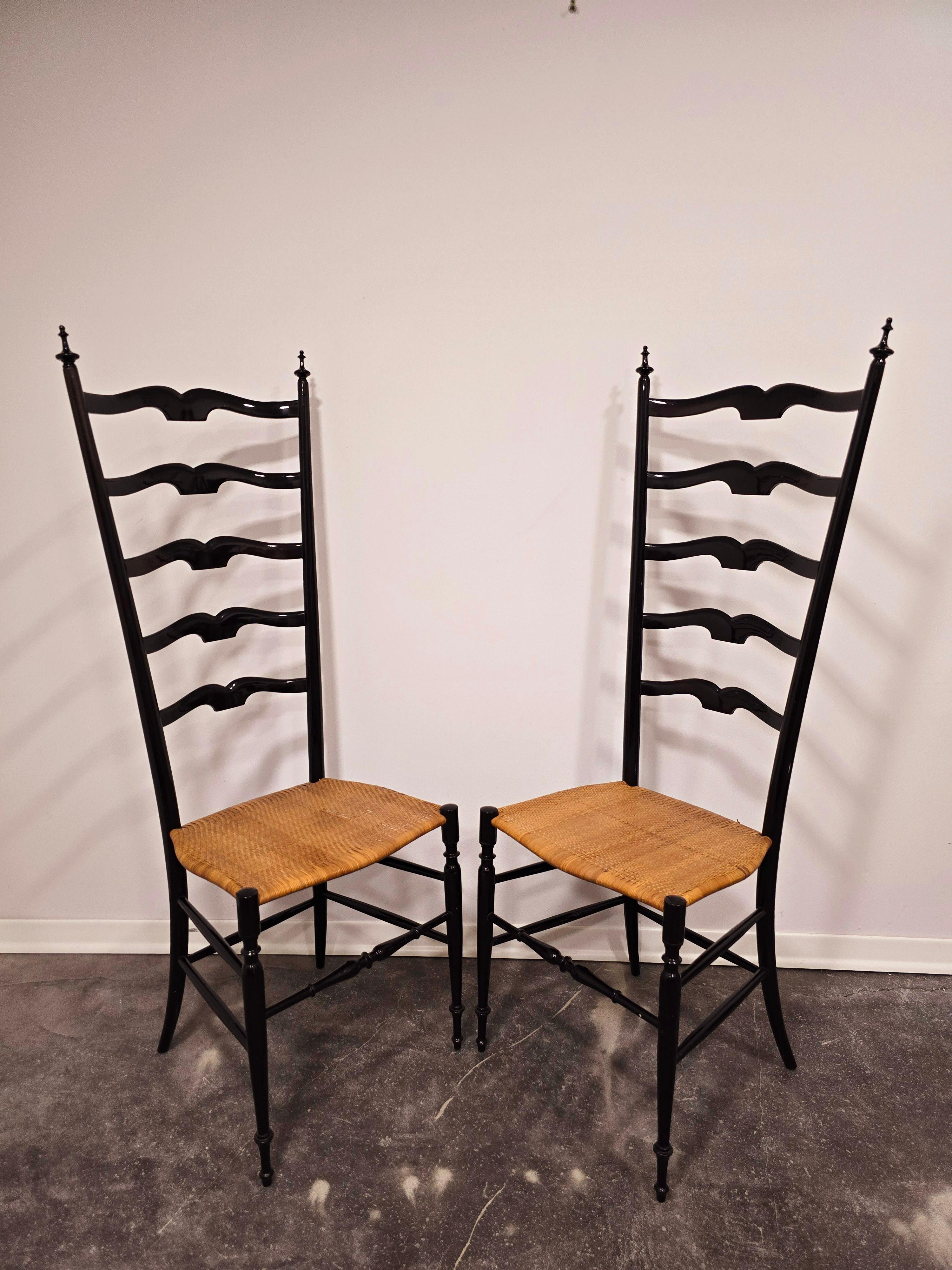 Pair of beautiful ladder high-back chairs by Chiavari in 1950s Italy.

Ebonized hard wood with slim cane seat. Chairs are extremly light and firm. Patina and condition is due to the age of produsction, burlt in really good condition.

Cane on seat
