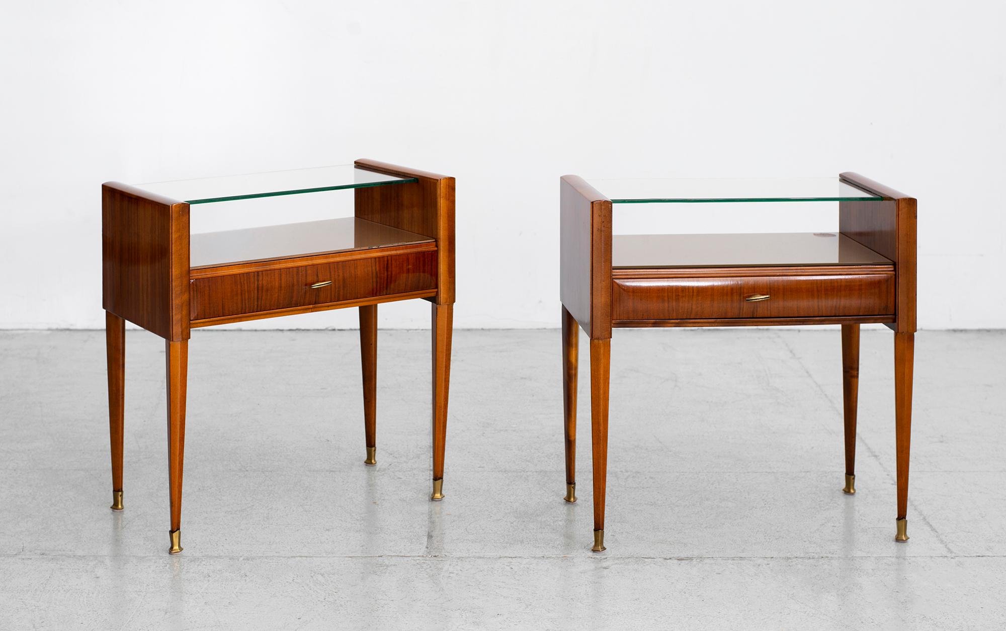 Exquisite pair of Italian nightstands by Paolo Buffa 
Original floating glass top. 
 Brass hardware and feet with tapered legs. 
 