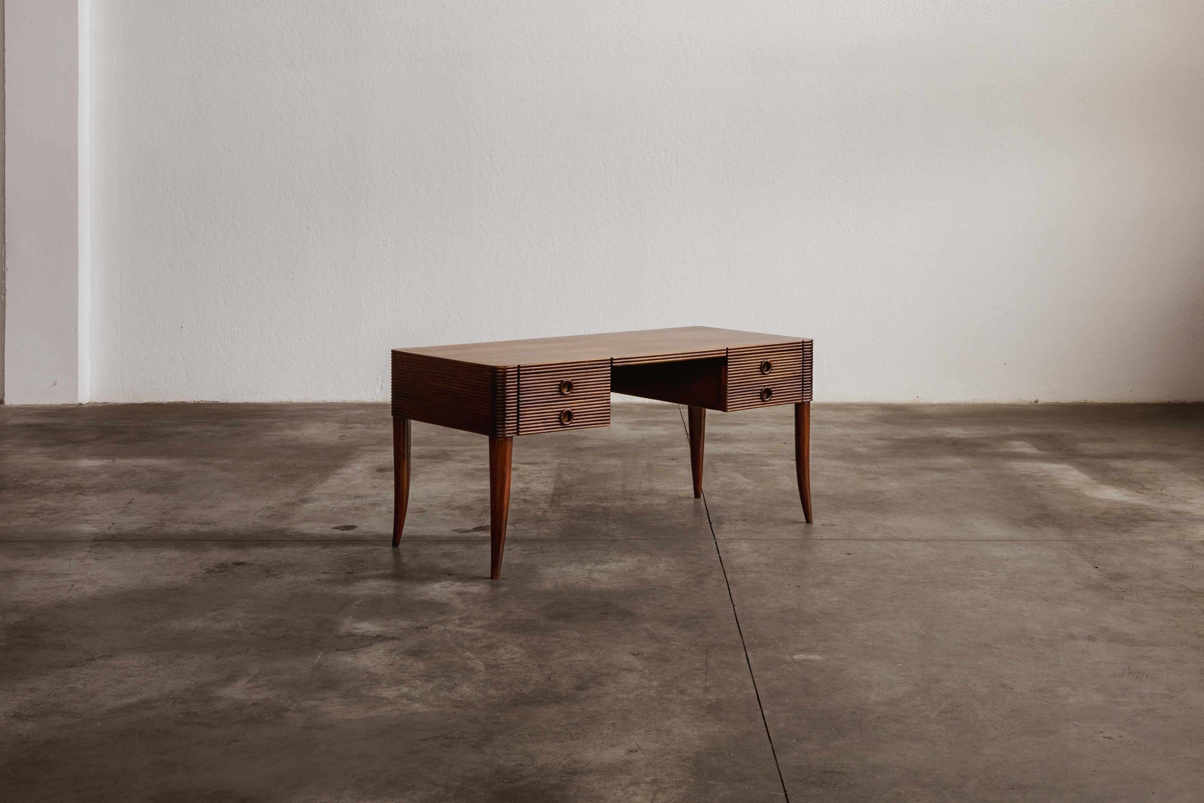 Paolo Buffa office desk for Galdino Maspero, wood, Italy, 1940s.

This desk, designed by Paolo Buffa and produced by Galdino Maspero in Italy around the 1940s, masterfully balances elegance and functionality. Constructed from light wood, the desk