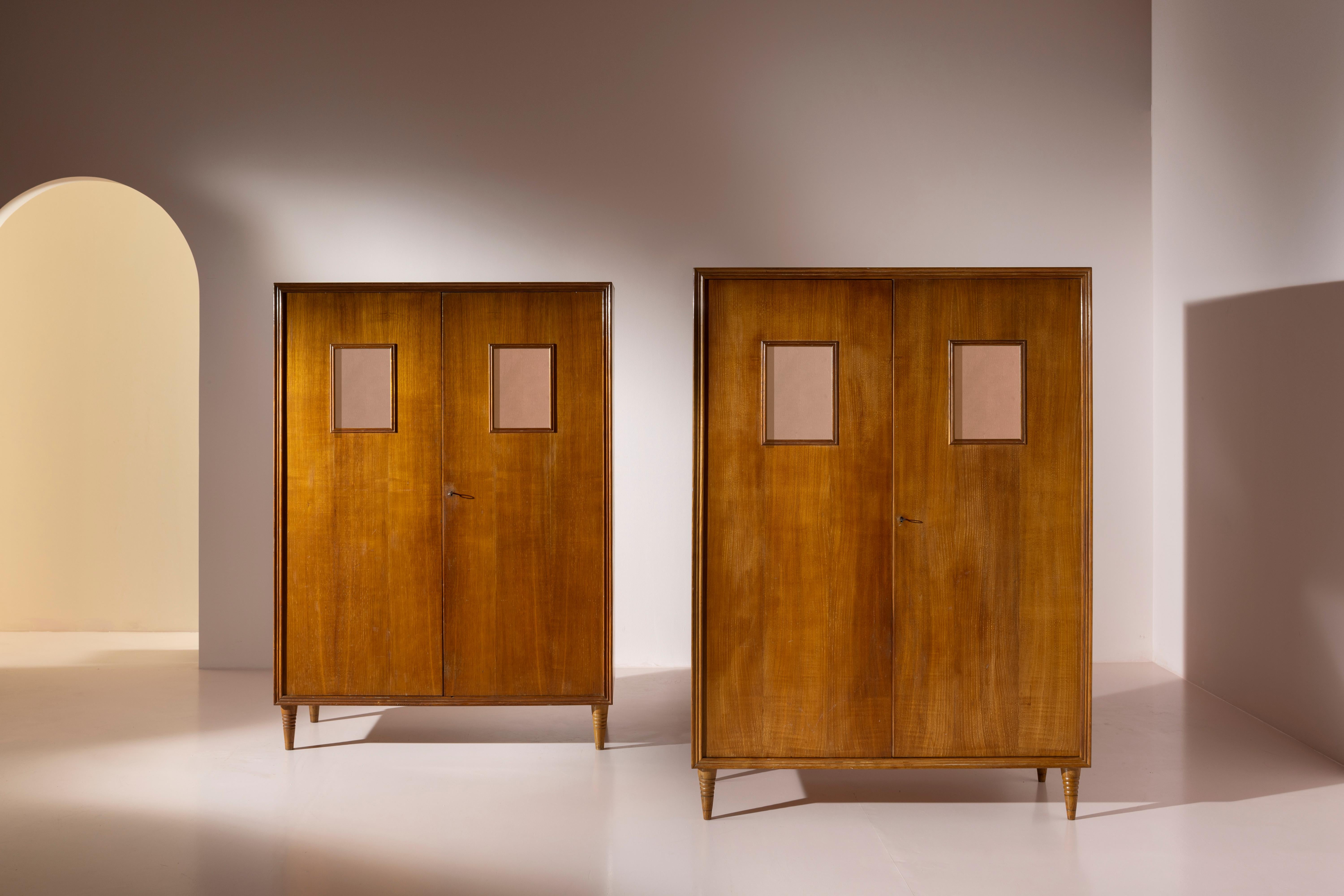 Pair of chestnut wardrobes with mirrored glass inlays, manufactured by Valzania in the late 1930s, designed by Paolo Buffa.

With a clean and elegant form, this pair of two-door chestnut wardrobes from the 1940s represents a transitional style that