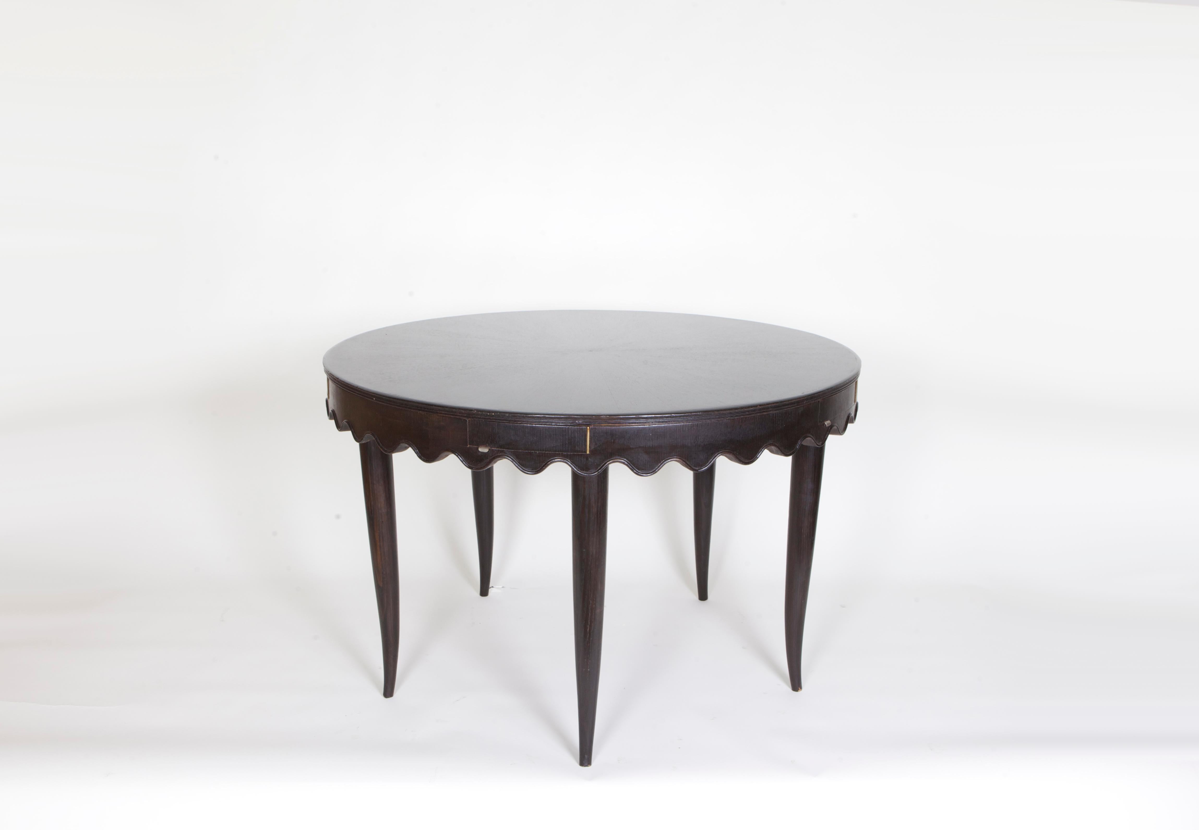Round game table by Paolo Buffa, circa 1955, in stained wood. Beautiful table in great condition with scalloped edges and four drawers.

Paolo Buffa was an Italian architect and designer best known for his designs of mid-Century Furniture.
