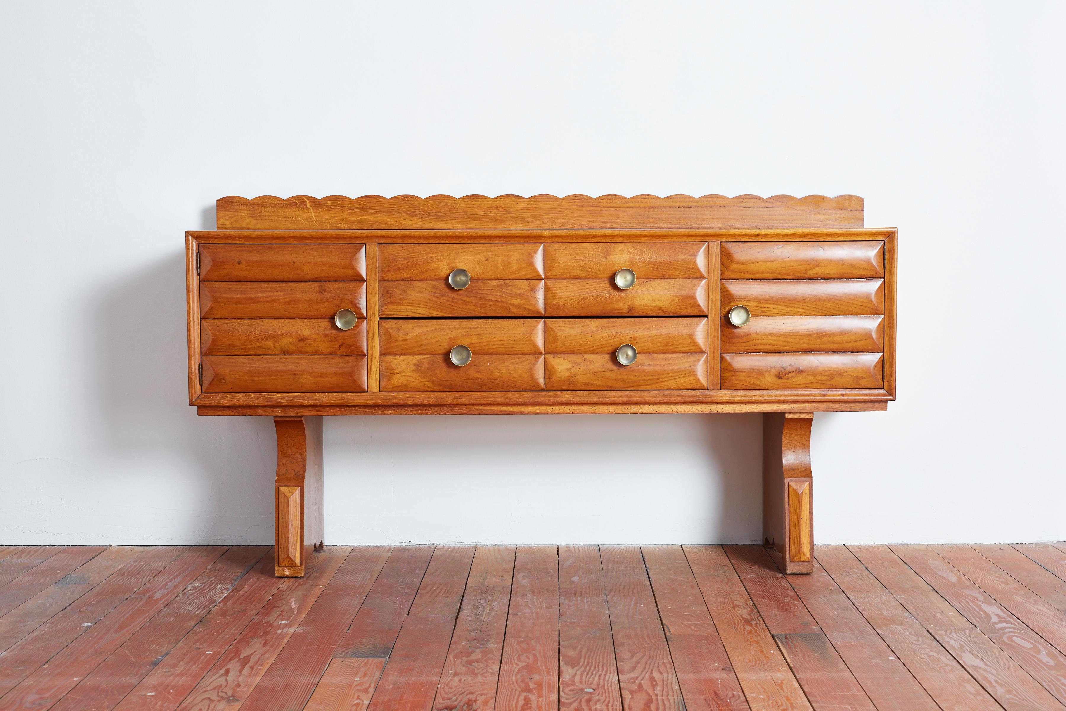 Gorgeous sideboard attributed to Paolo Buffa , Italy - 1940's 
Scalloped wood detailing with brass hardware and sculptural legs 
2 swinging doors and four drawers for storage 
Wonderful warm patina 
