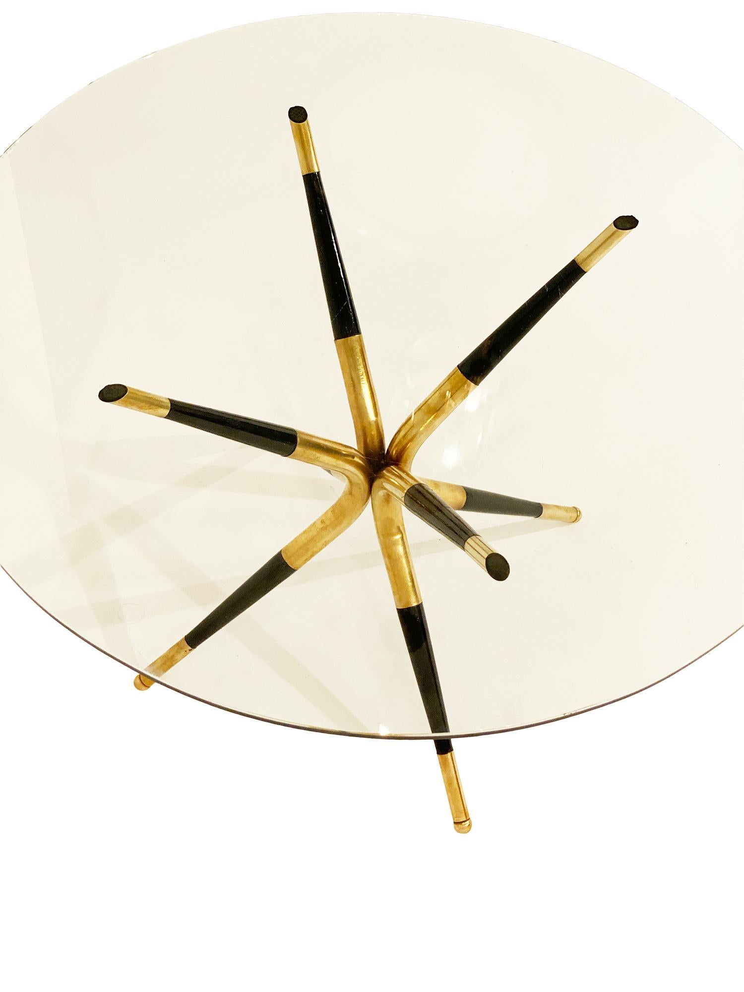 Paolo Buffa style side table featuring four legs combining brass and ebonized wood. By iconic Italian designer Paolo Buffa, this piece has a clear glass top and superb style!