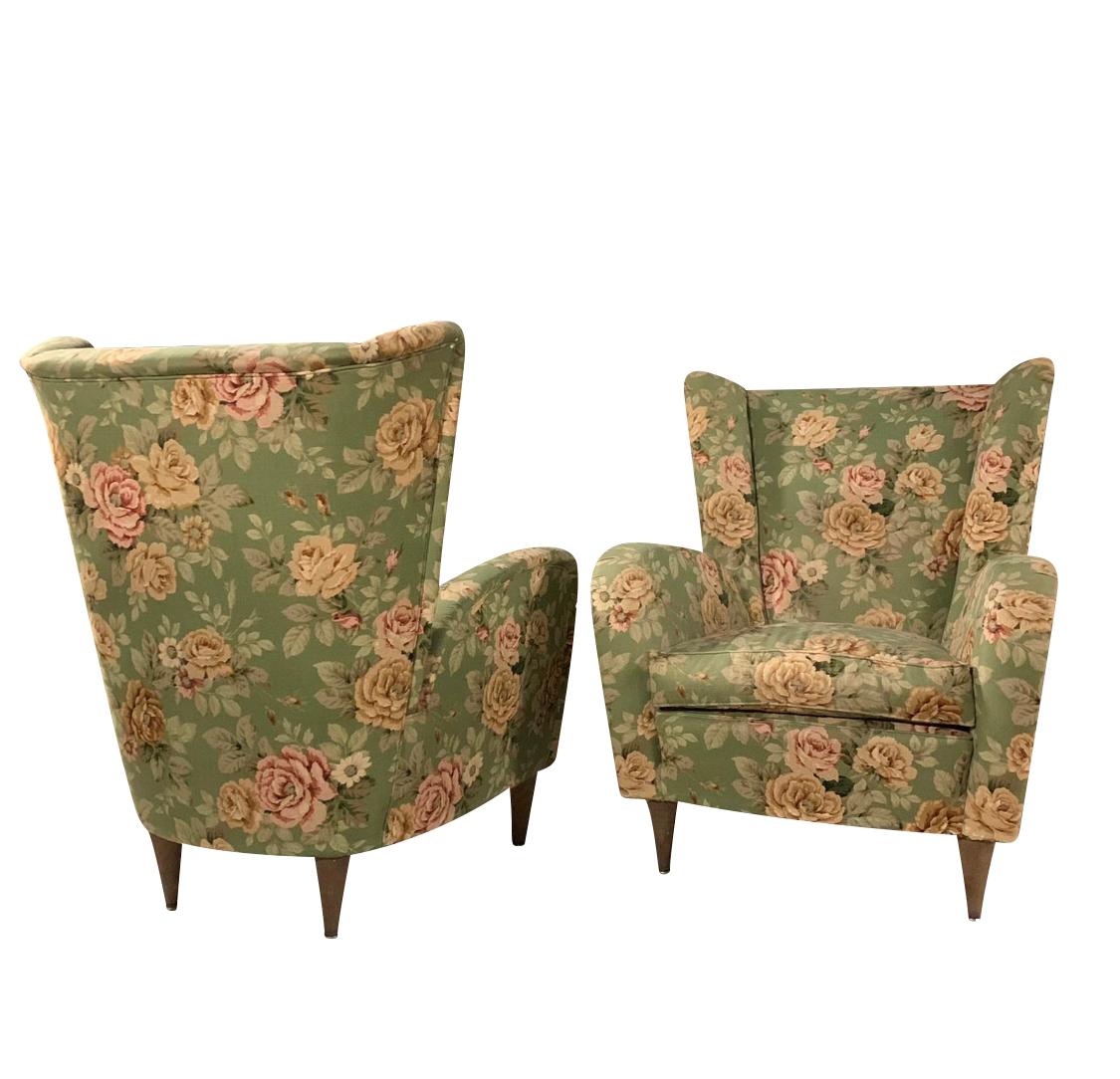 Paolo Buffa style pair of armchairs in original 50's floral fabric and tapered wooden feet.

Chairs can be reupholstered per clients design requirements.