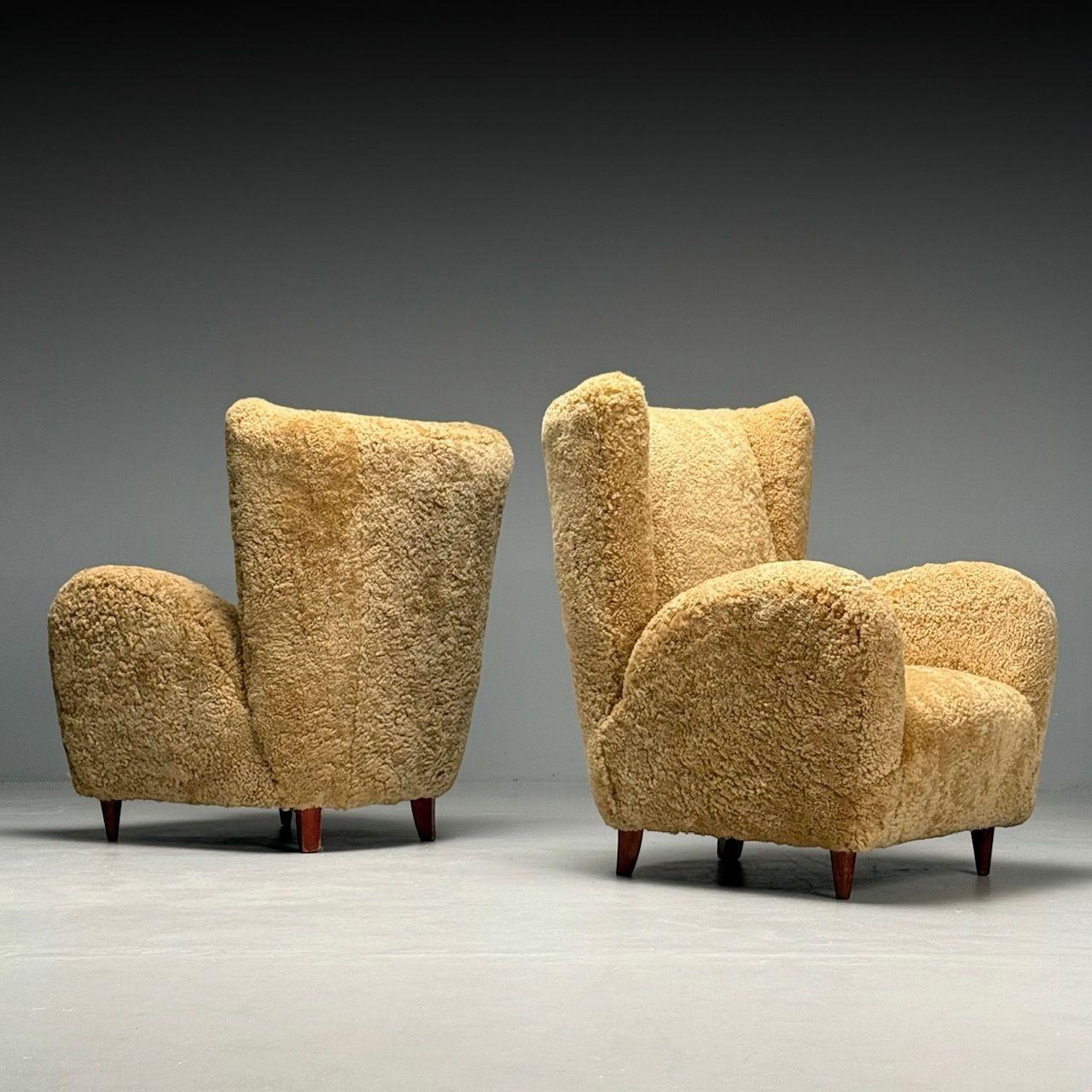 Paolo Buffa Style, Italian Mid-Century Modern, Lounge Chairs, Honey Shearling or Sheepskin, Italy, 1940s

This pair of organic form lounge or armchairs, designed in the style of Paola Buffa and produced in Italy circa the 1940s, embodies a perfect