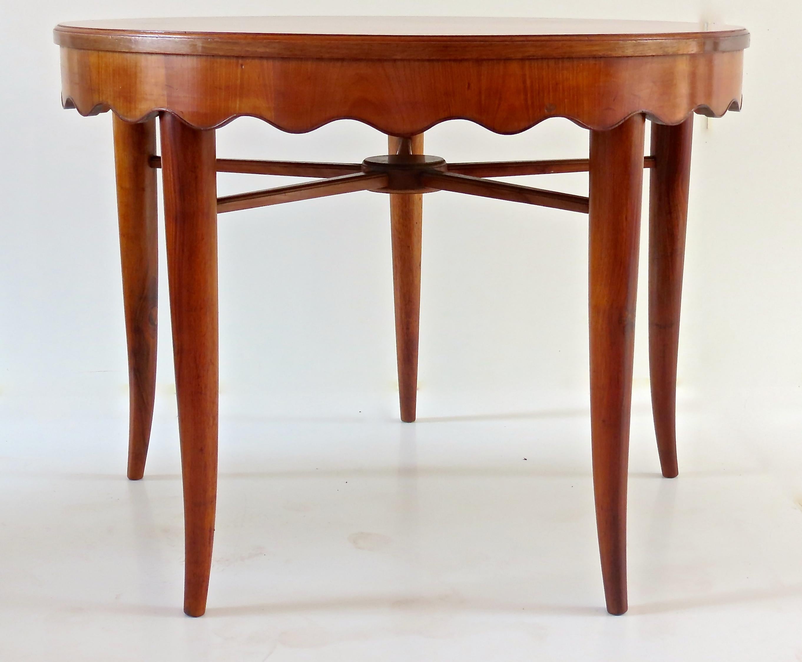 Large rare Paolo Buffa round dining table, cherrywood, circa 1950
five conical saber legs and scalloped edges
executed by Mario Quarti, Cantu
Measures: height 80cm, diameter 106 cm
Good condition, very good original patina.
Together with a