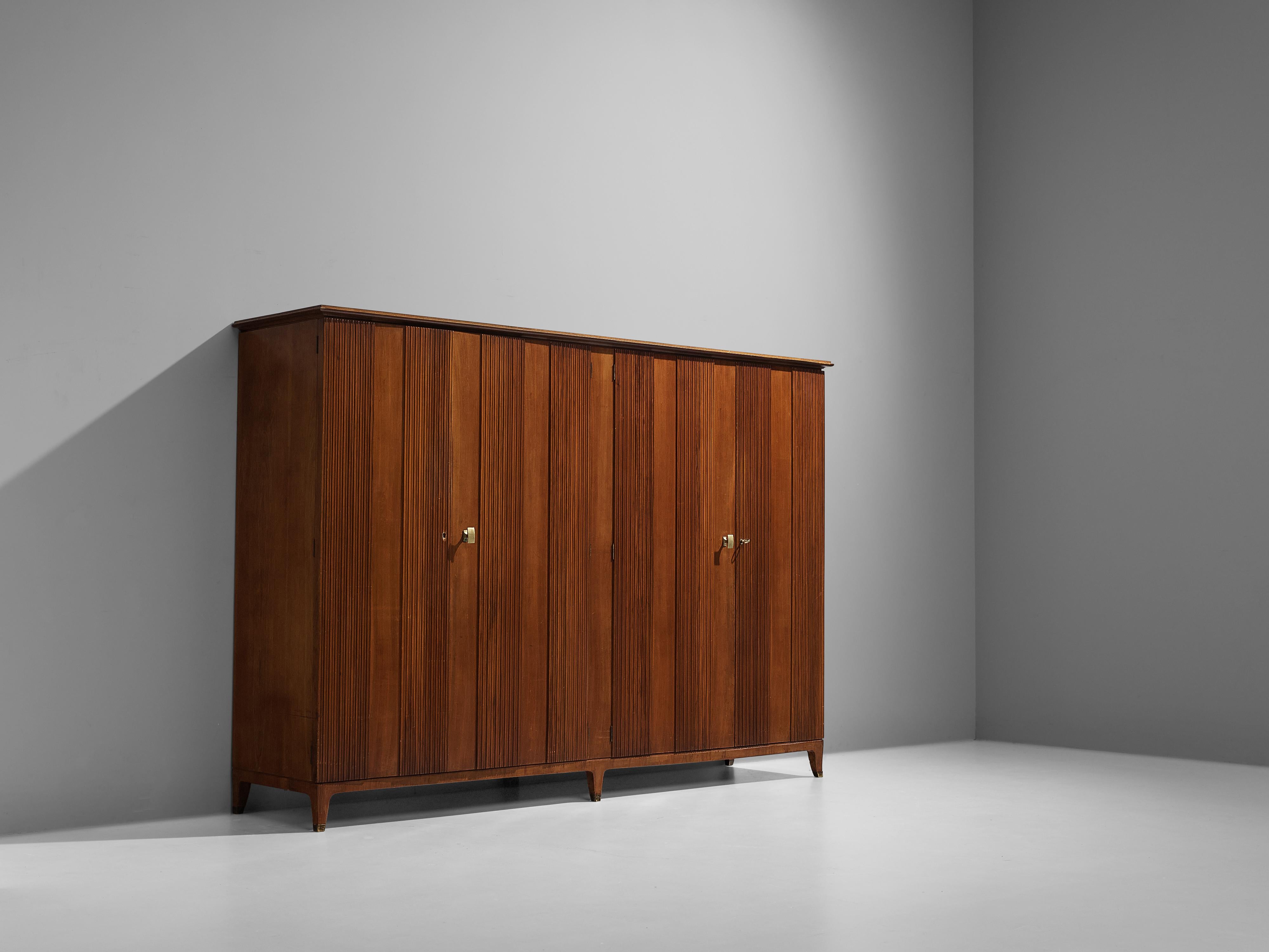 Paolo Buffa, wardrobe, walnut, ashwood and brass, Italy, 1950s

This grand wardrobe is executed in warm Italian walnut with brass details. The doors are finished with vertical wooden slates that run from the bottom all the way to the top, creating a
