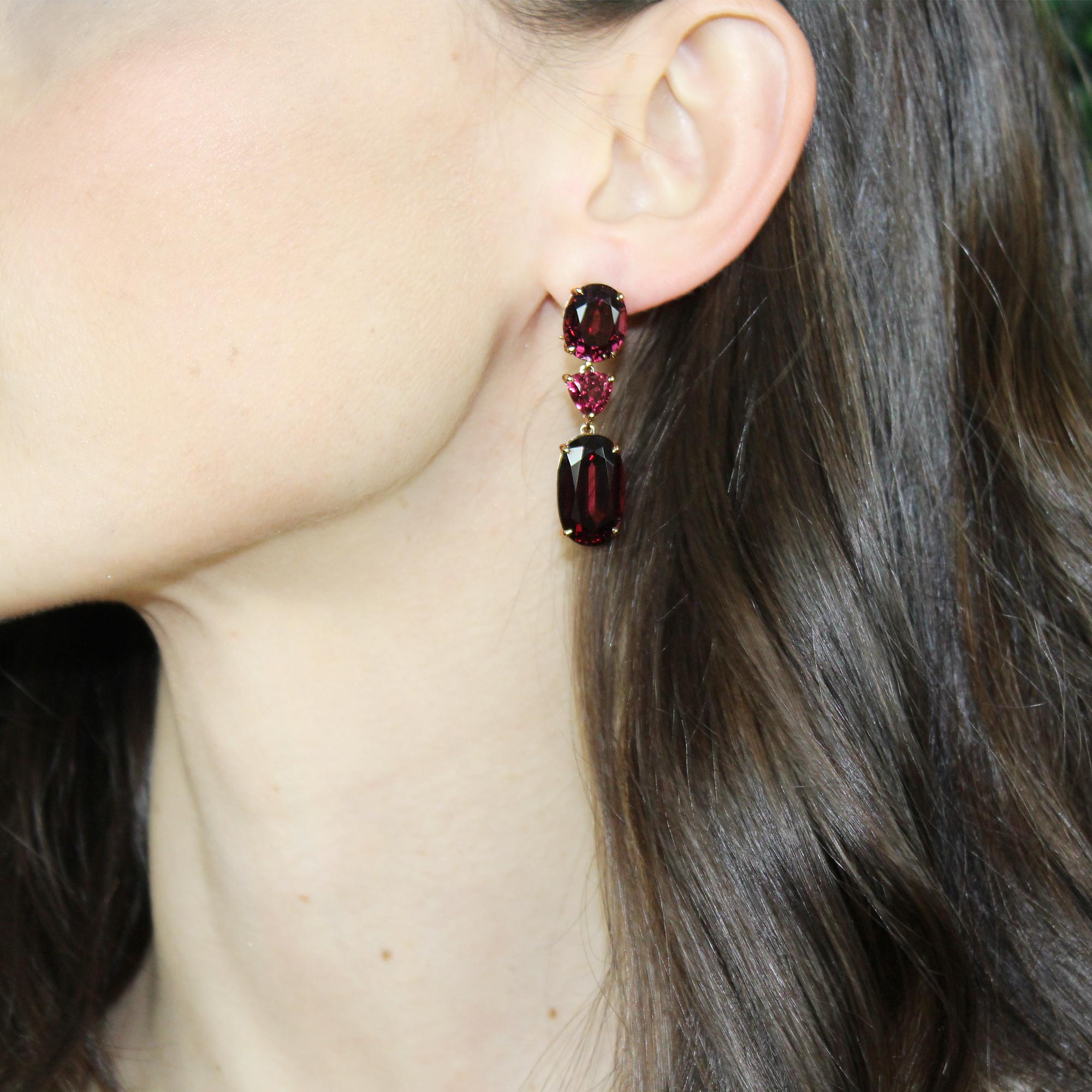 One-of-a-kind oval and trillion-shaped three stone rhodolite garnet earrings set in 18 karat rose gold with pave-set round, brilliant diamonds.

The weight of each earring will not pull down the ear and is designed specifically for maximum comfort.