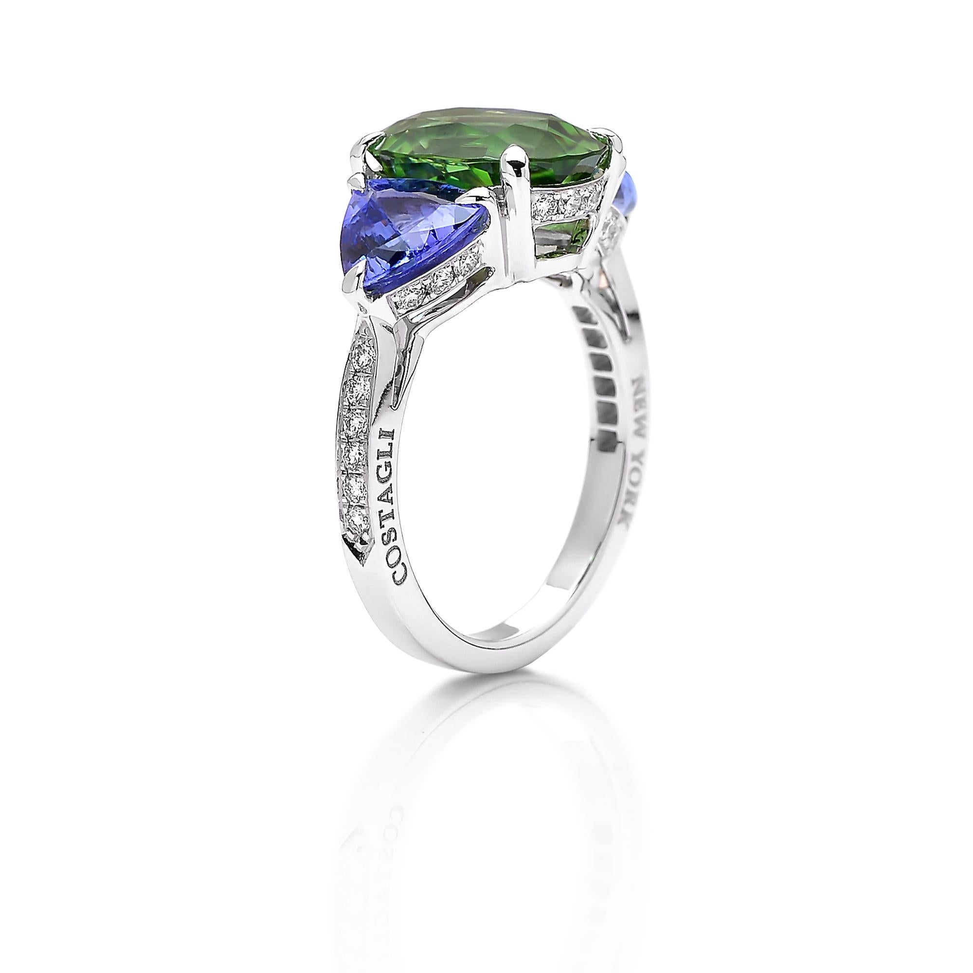 One of a kind 18 karat white gold ring features an oval-shape chrome tourmaline ring flanked by two trillion-shape tanzanites with round, brilliant diamond detailing. 

This ring is a testament to Paolo's expert eye for color. The chrome color of
