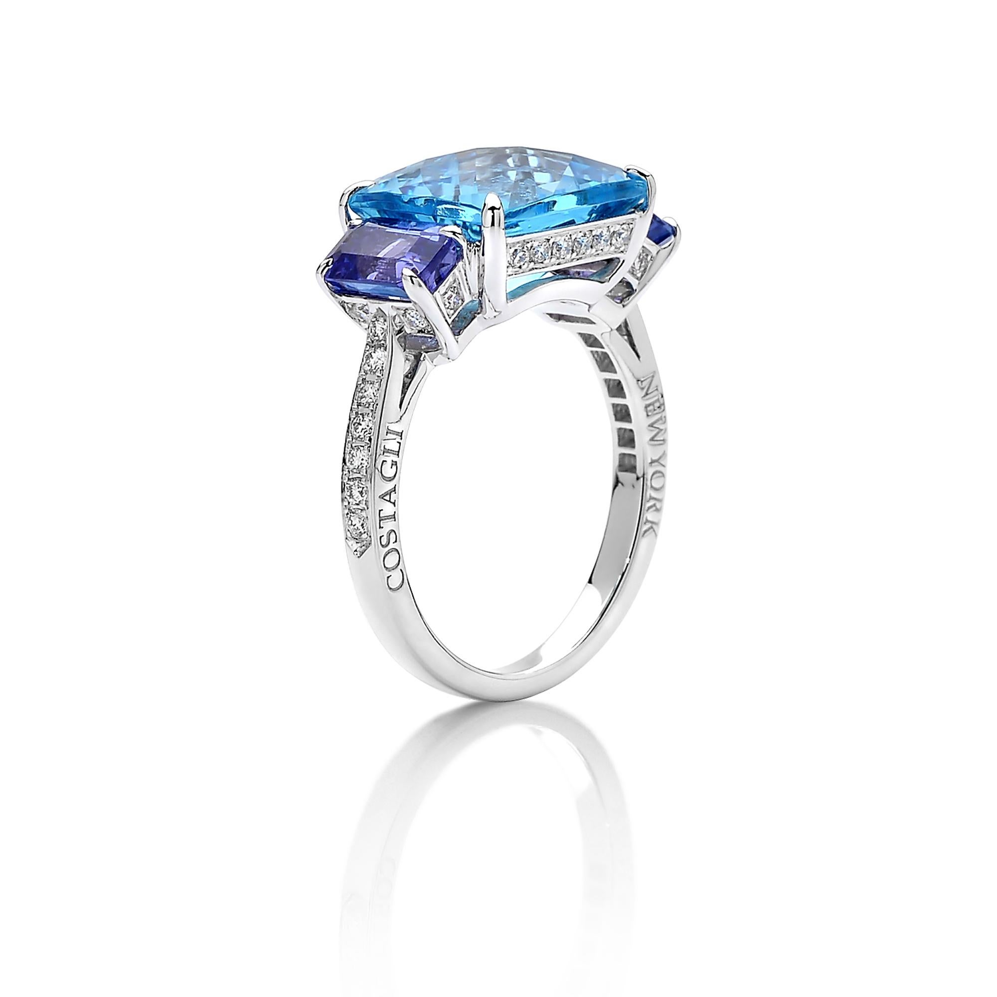 One-of-a-kind emerald-cut Swiss Blue Topaz ring with trillion-cut tanzanite side stones set in 18 karat white gold and pave-set round, brilliant diamond detailing. 

A classic ring silhouette paired with the unique color combination makes this jewel