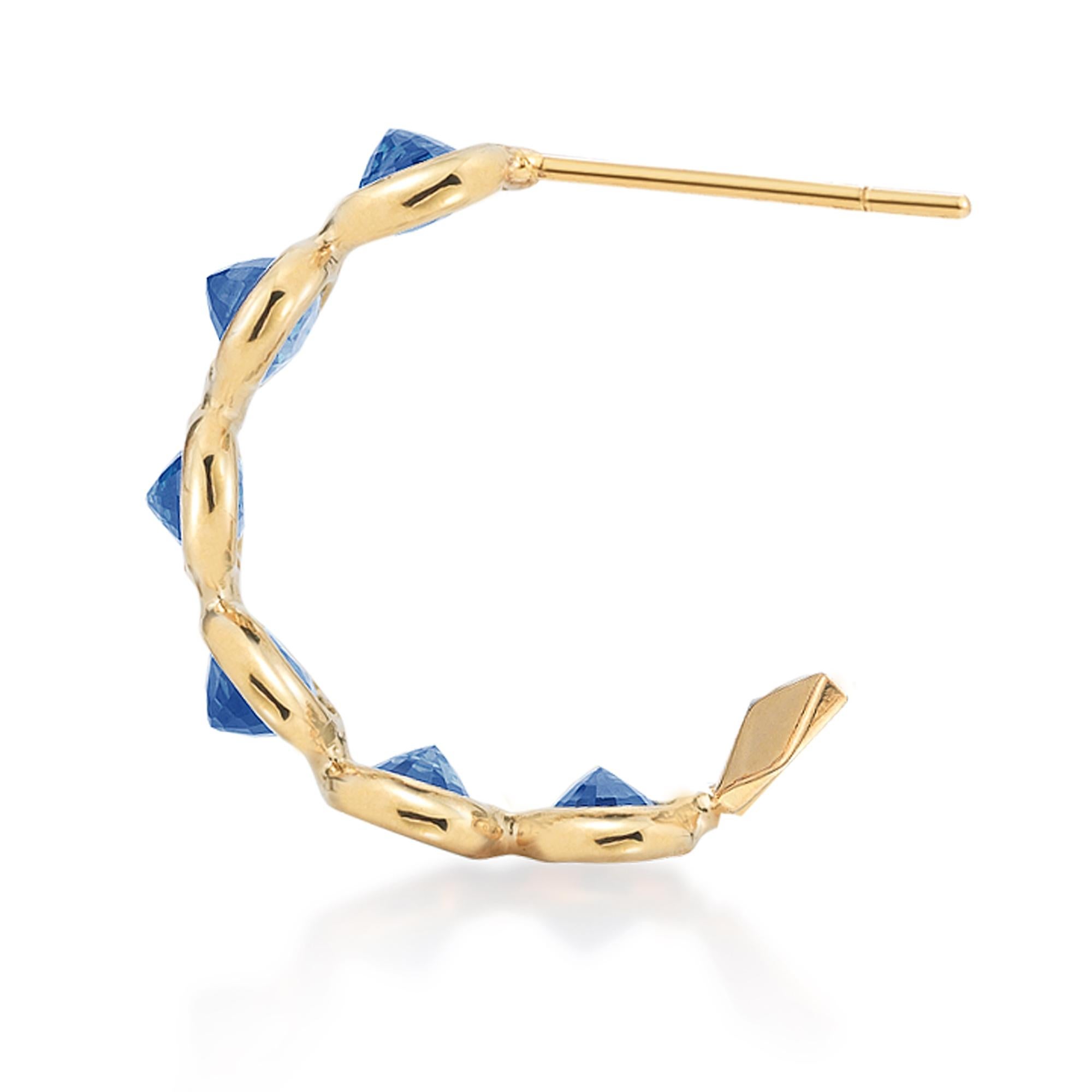 18kt yellow gold Ombré hoop earrings with bezel set multishade oval blue sapphires and signature Brillante® motif, petite. 

Reimagined from summers spent at the Tuscan shore, the Ombré collection highlights the diverse hues and textures found in