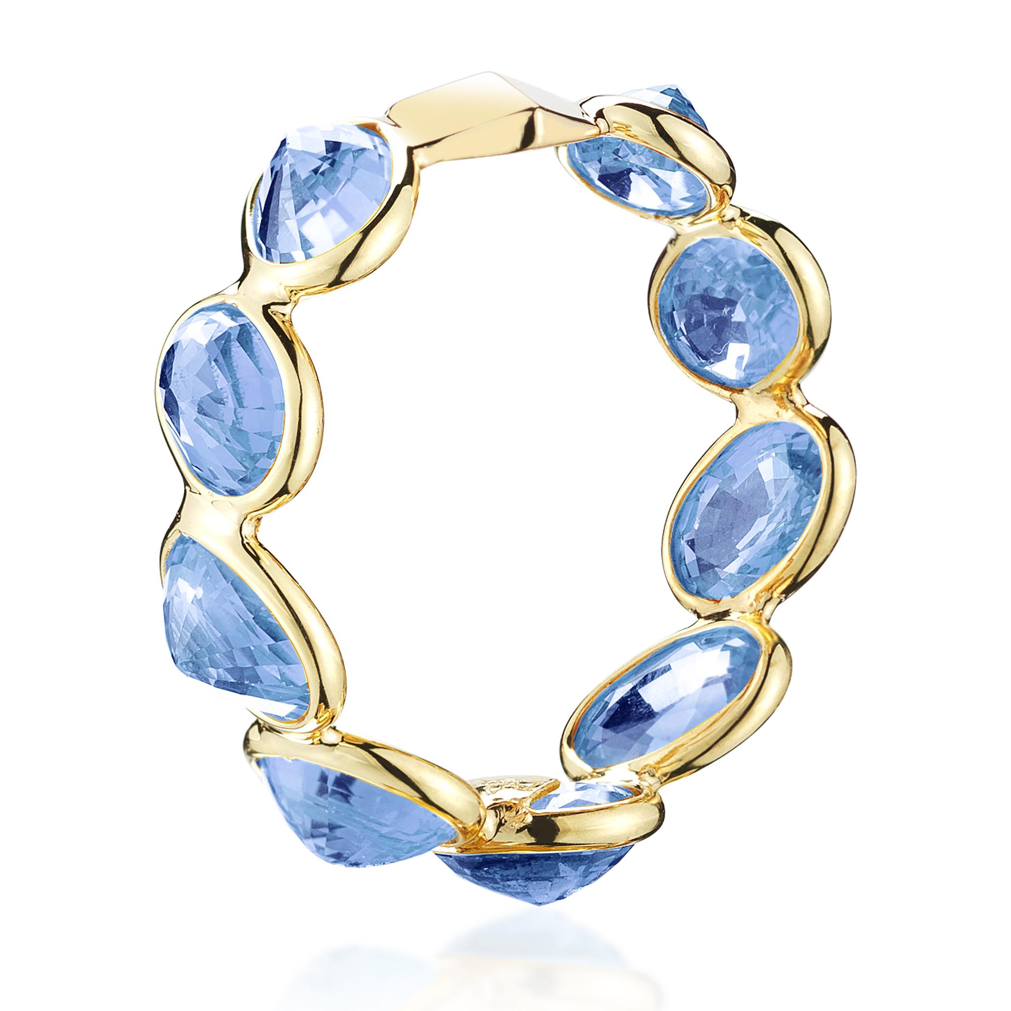 The 18kt yellow gold Ombré band set with multishade oval blue sapphires at 11 o'clock® with signature Brillante® motif.

An ode to the Mediterranean Sea, Paolo Costagli crafts sparkling blue sapphires into a ring made in 18kt yellow gold. The ring