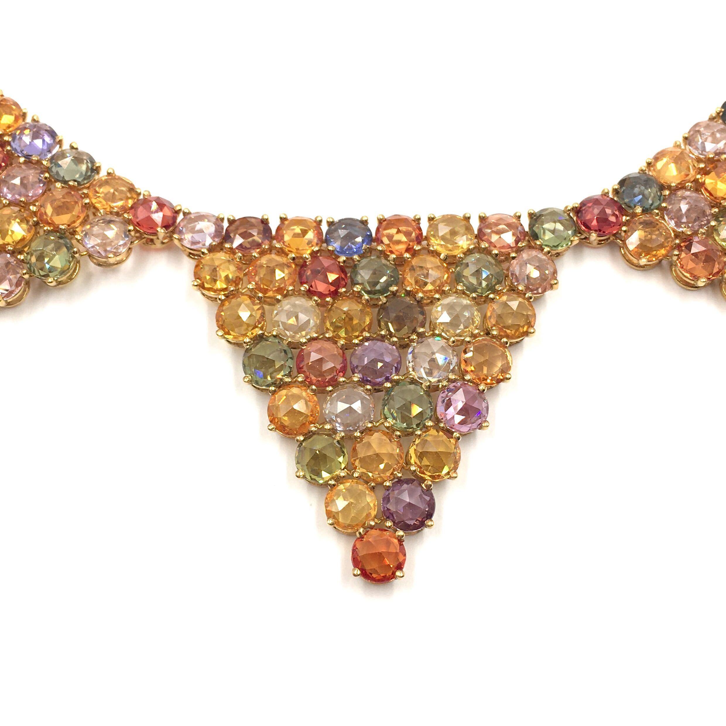 An 18 karat yellow gold and multi colored sapphire necklace. Paolo Costagli. Designed as graduated rose cut diamond articulated panels, set with rose cut blue, green, yellow, orange and pink and purple sapphires. The sapphires weigh approximately