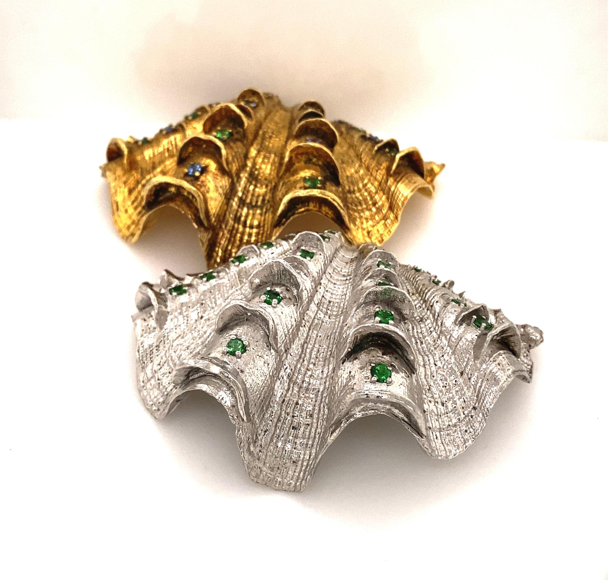 Paolo Costagli Sterling Silver Gilt Shells With Sapphires Tsavorite Garnets.  This is a beautiful pair of shells by important artist Paolo Costagli. One shell has 2 carats of Tsavorite Garnets the other has 2 carats of alternating blue sapphires and