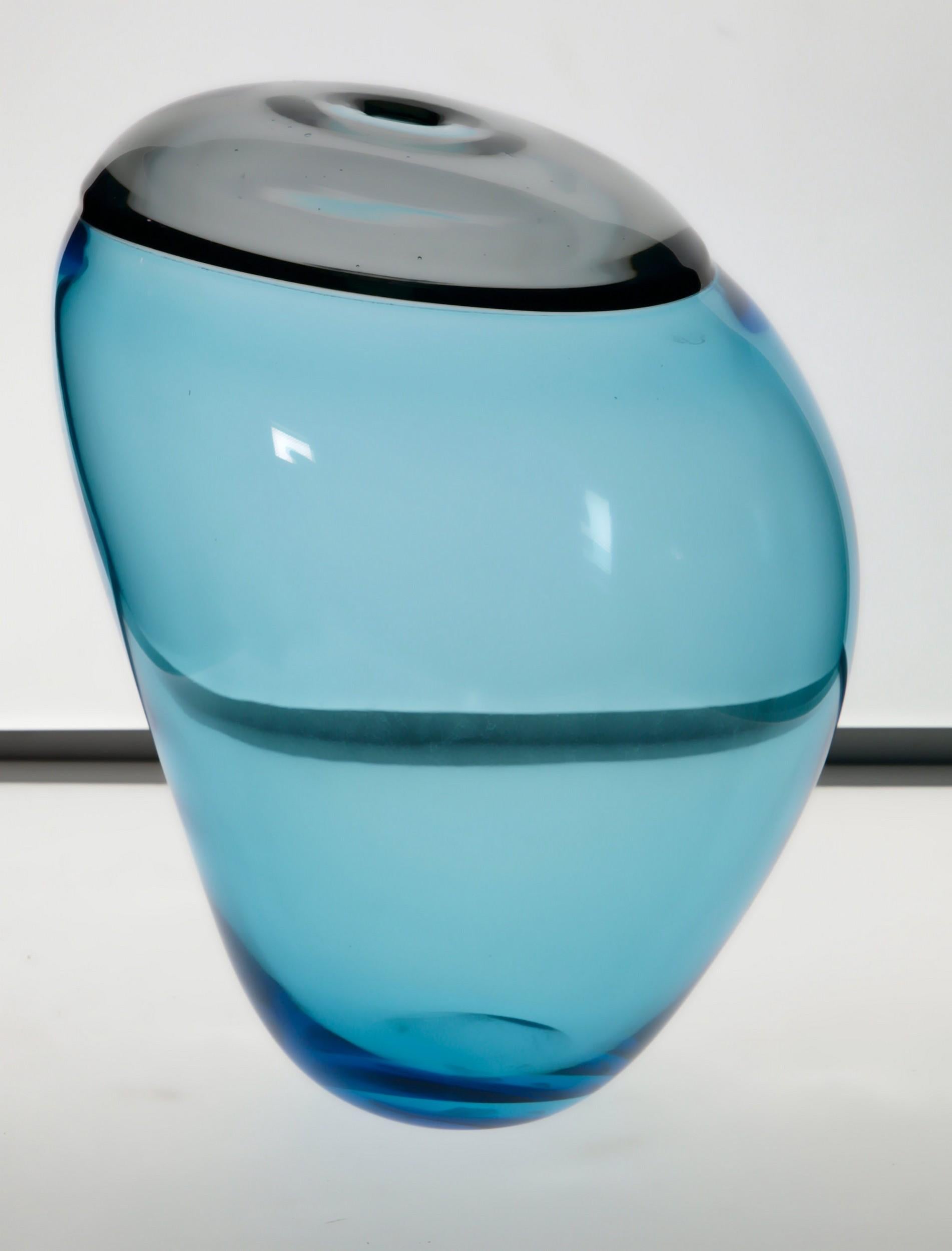 Paolo Crepax asimmetrico vase. The vase made of two separate parts joined together called incalmo. The main part is in Bluino, the upper part is in Grigio Acciaio (a warm gray). 

Paolo is famous for his ability with the incalmo technique. He is