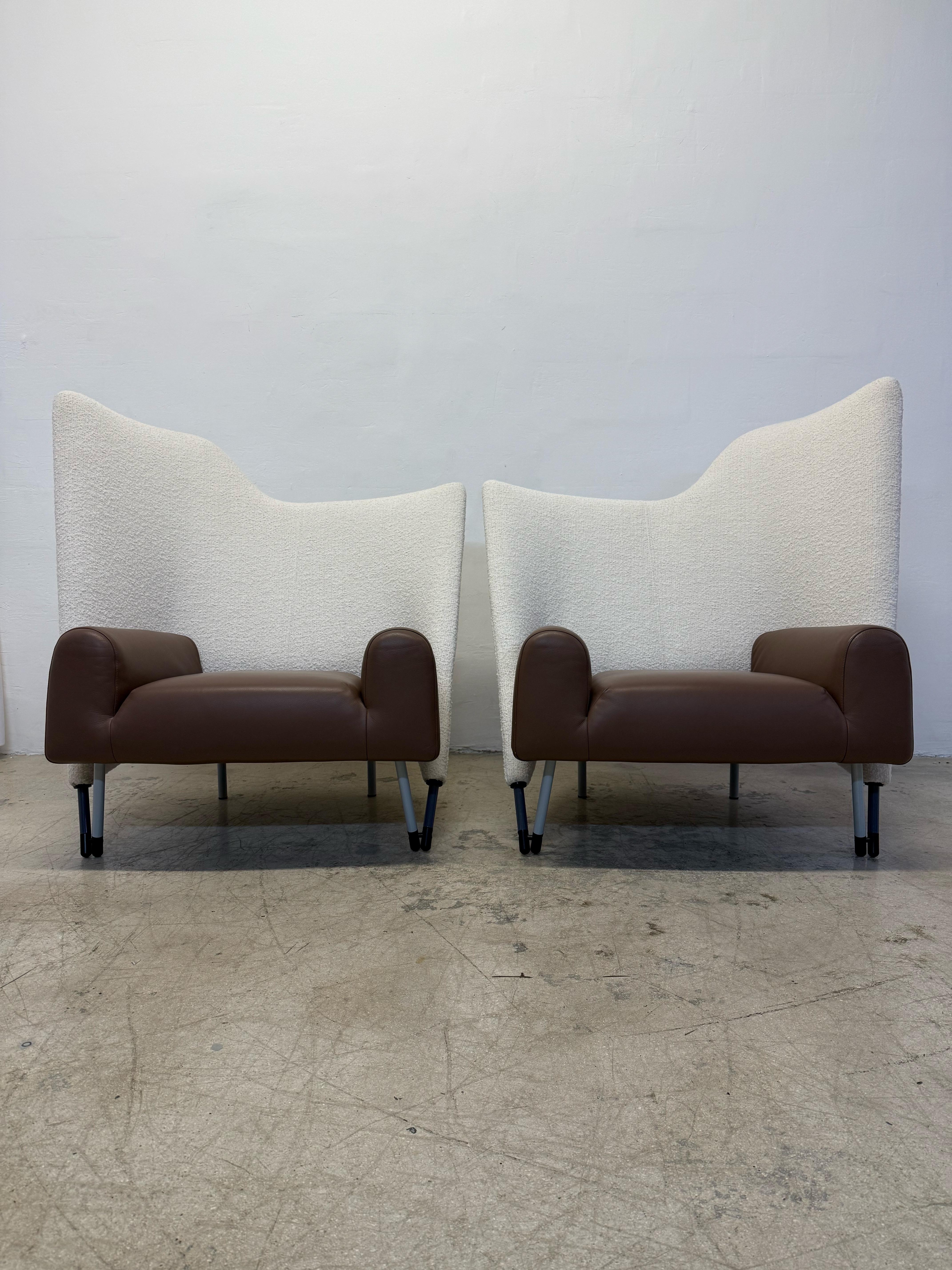 Pair of opposing postmodern Torso arm chairs with original brown leather seats and newly upholstered boucle backs designed by Paolo Deganello for Cassina.  Originally designed by Daganello in 1984, these chairs were produced in the late 1980s. The