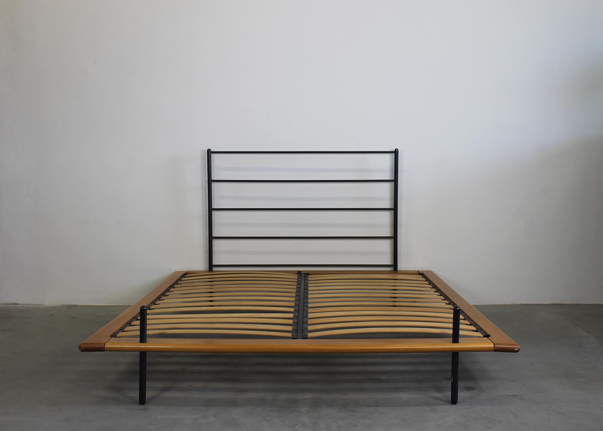 Acquariano bed structure with frame and slats in beech wood, headboard and legs in black painted steel. 
Designed by Paolo Pallucco and produced by Pallucco in the 1980s. 

Pallucco, moving away from the dominant styles, has always experimented