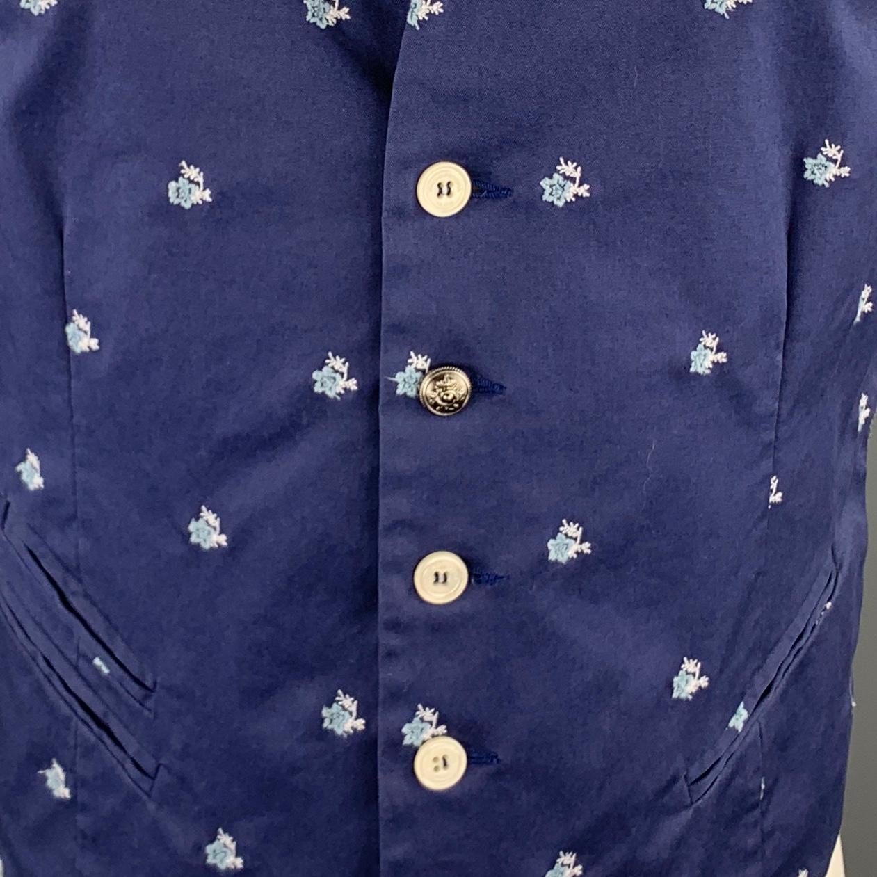 PAOLO PECORA vest comes in blue cotton twill with an all over floral embroidery pattern, striped back belt, and inverted notch lapel neckline.  Made in Italy.

Excellent Pre-Owned Condition.
Marked: IT 48

Measurements:

Shoulder: 12.5 in.
Chest: 40