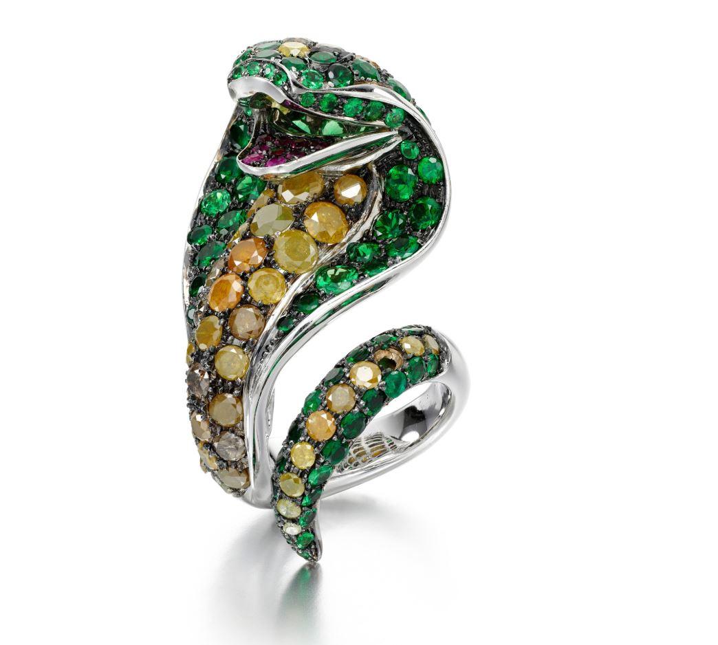 Designed as a coiled cobra, pavé-set with circular-cut tsavorite garnets, brilliant-cut diamonds of various yellow, orange and brown tints, and its mouth accented with circular-cut rubies, size J, signed P. Piovan, Italian maker's mark.
The Stamped