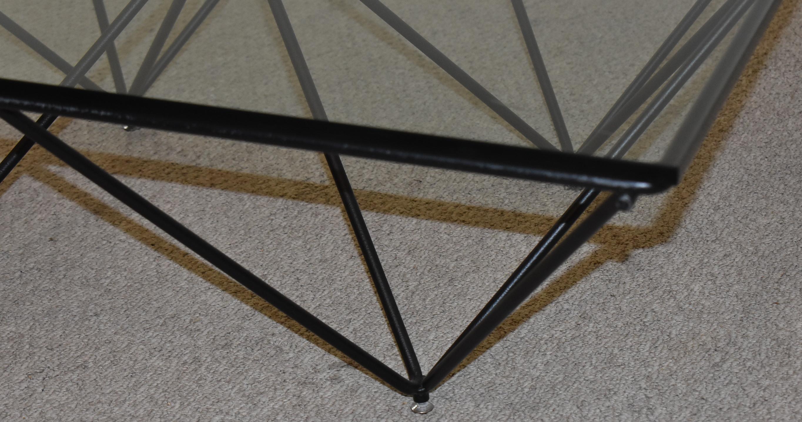 Geometric form iron base coffee table with a glass top titled Alanda designed by Paolo Piva. 40