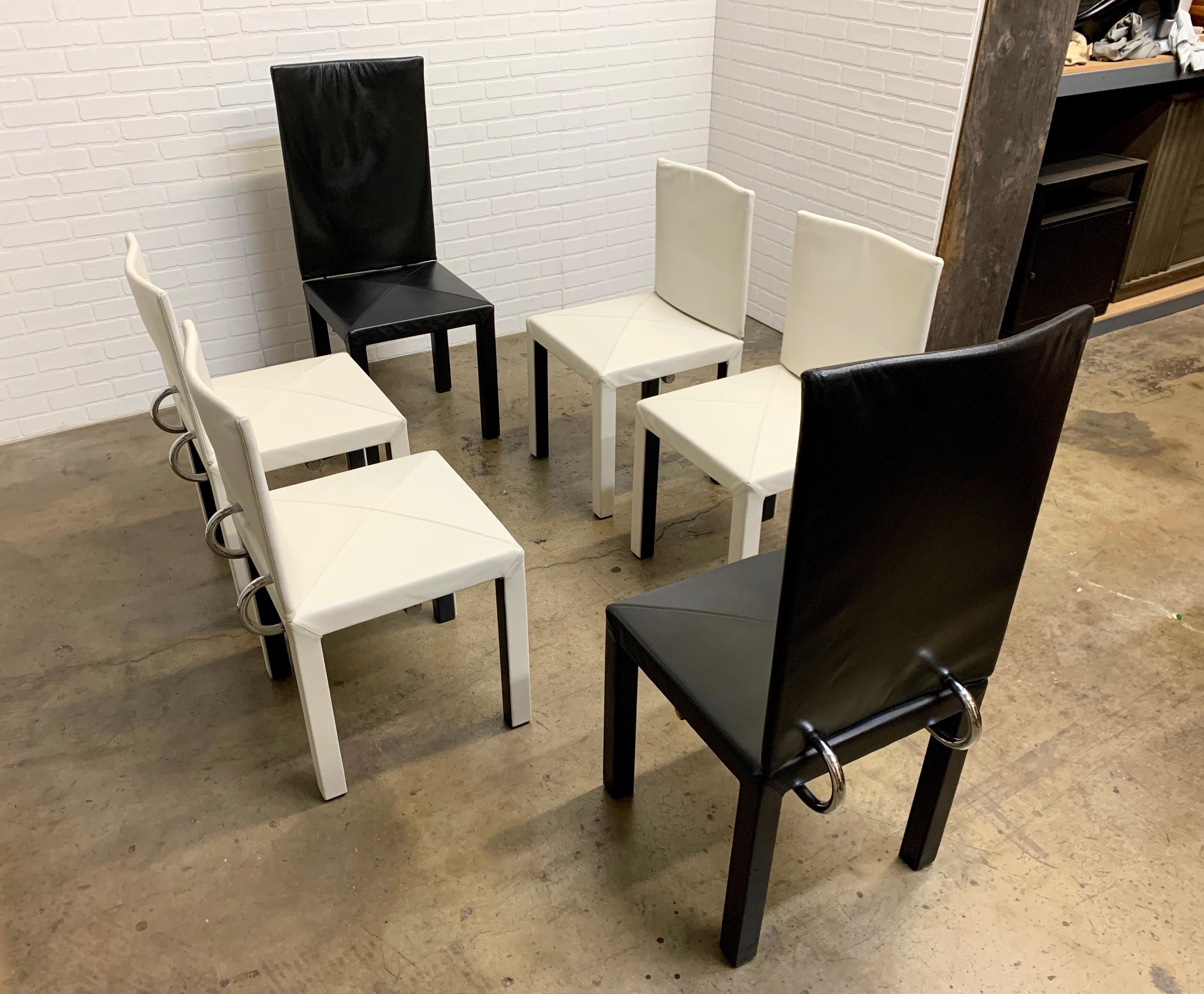 Six vintage-modern Italian dining chairs with two high back and four low back in a combination of black and white leather. Designed by Paolo Piva for B&B Italia. Striking Italian modern chairs. 
The black chairs are 43.75