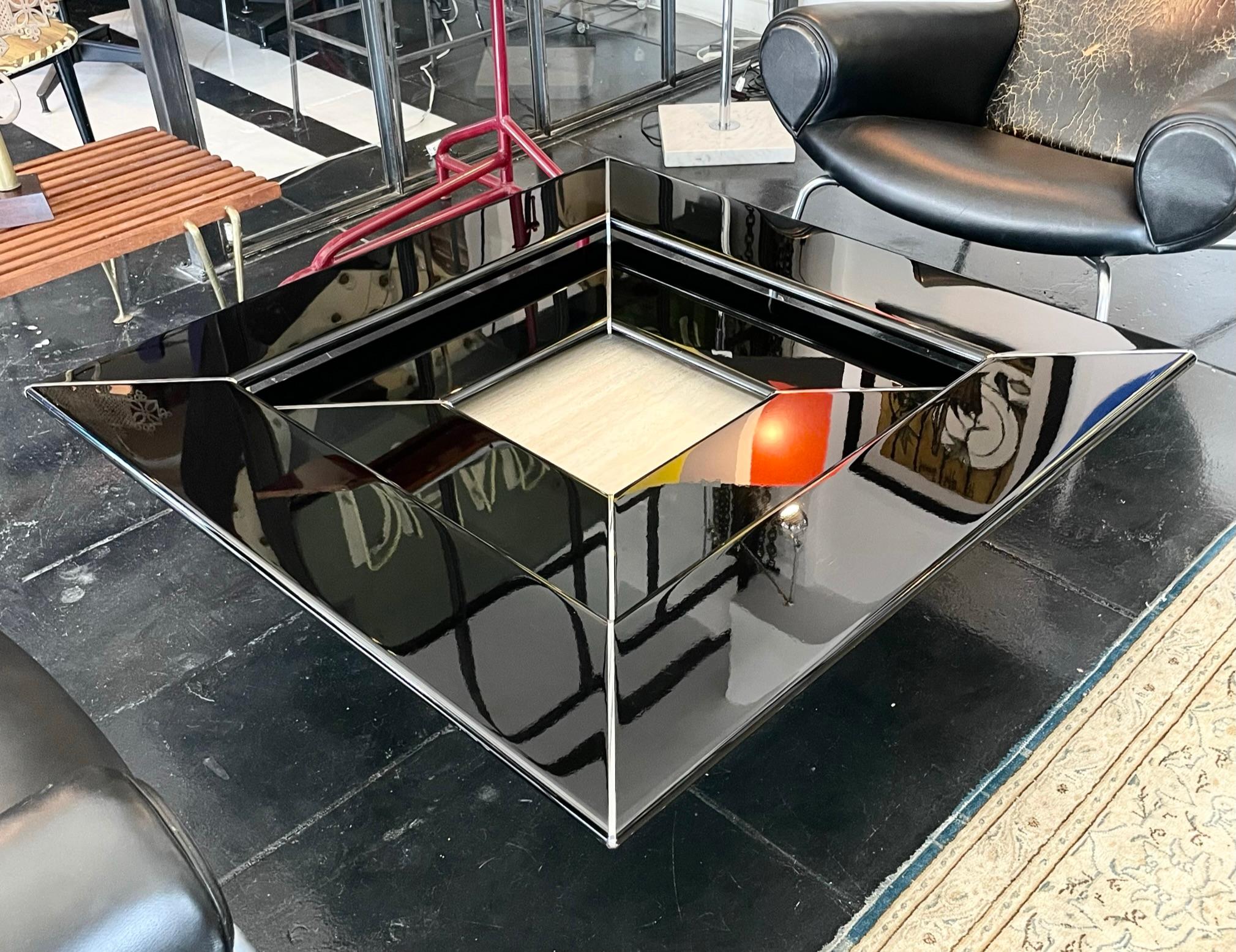 Beautiful 3-dimensional coffee table by Paolo Piva, 1970s. Black lacquer with silver trim, travertine base in great condition.