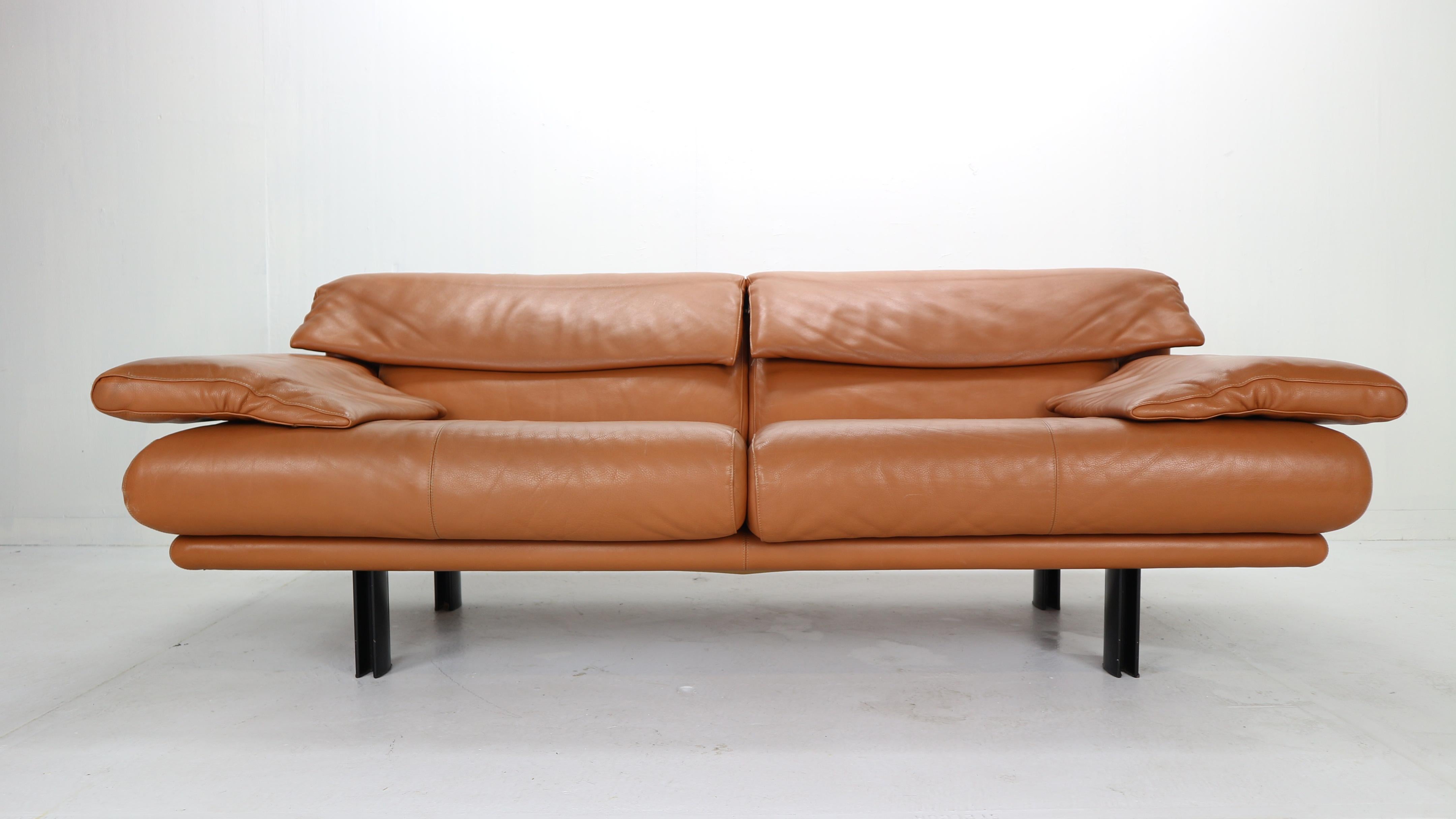 Cleverly designed 'Alanda' sofa by Paolo Piva for B&B Italia in 1980s, Italy.
Cognac colour leather seatings. 
Adjustable armrests and backrests supported by four black enamel metal legs.
An extremely elegant and comfortable sofa. 
Retain original