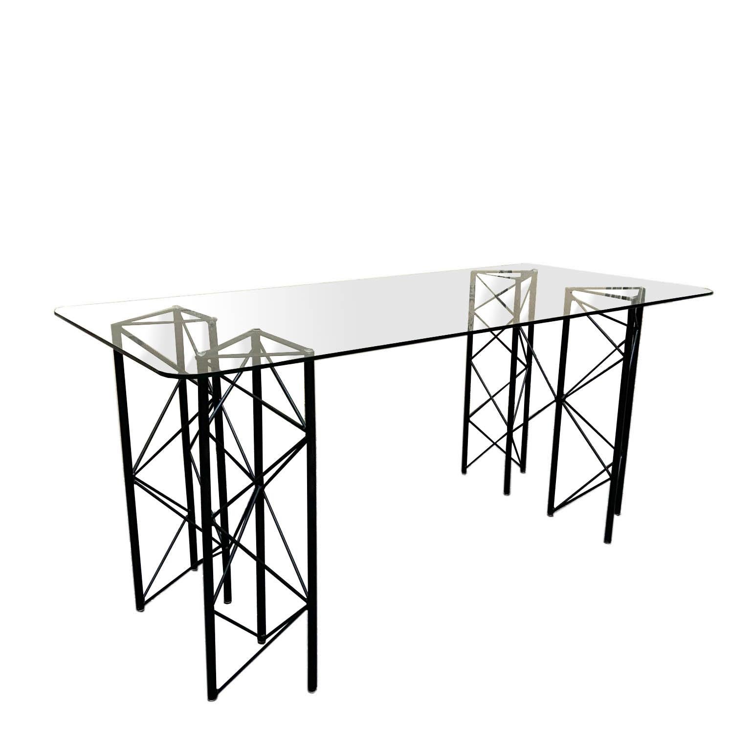 Rectangular dining table with geometric black lacquered metal frame and transparent glass top, in the style of Paolo Piva 1970.
 