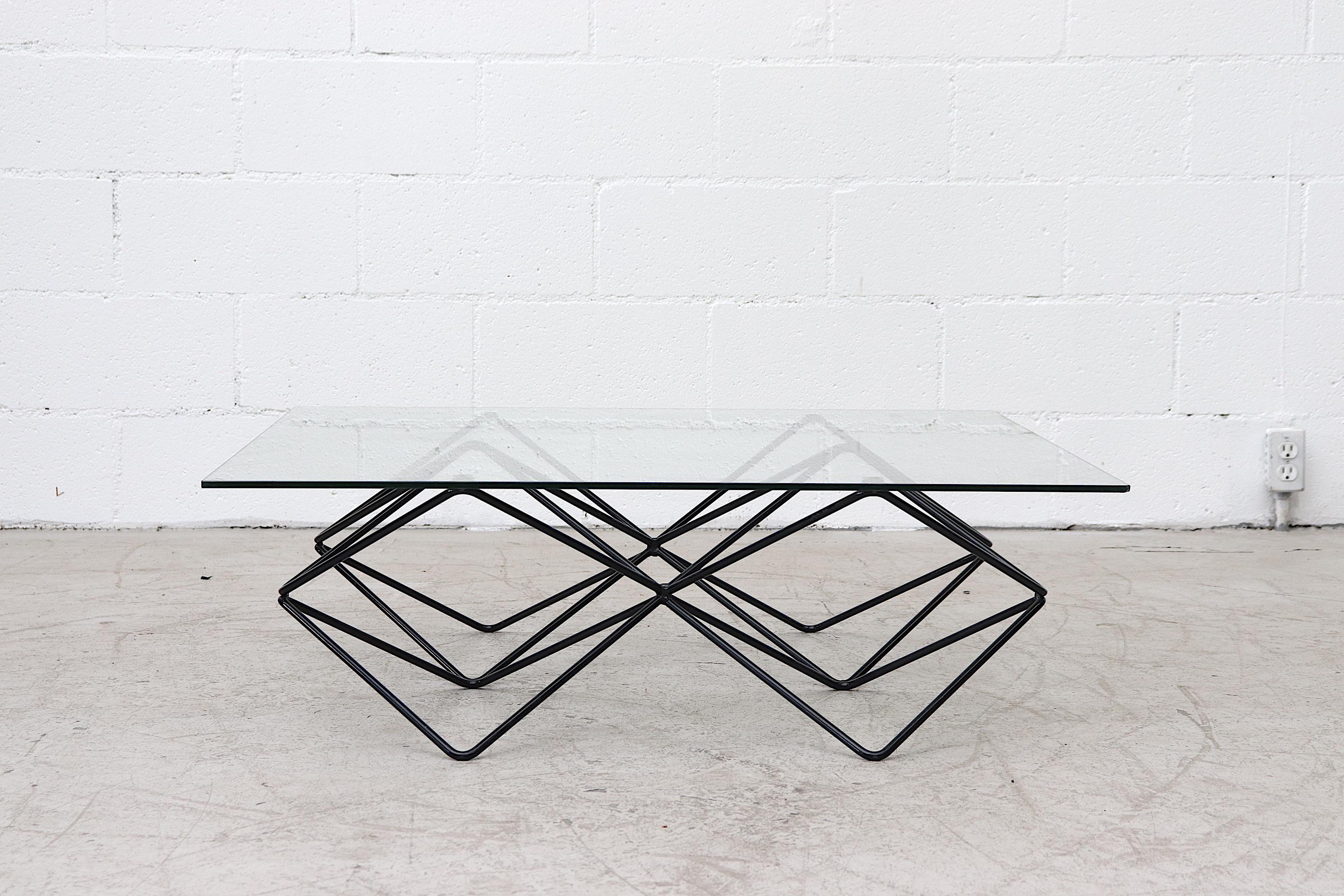 Architectural Paolo Piva style geometrical coffee table with black wire metal frame, square glass top and leveling feet. In original condition with visible signs of wear consistent with age and usage.