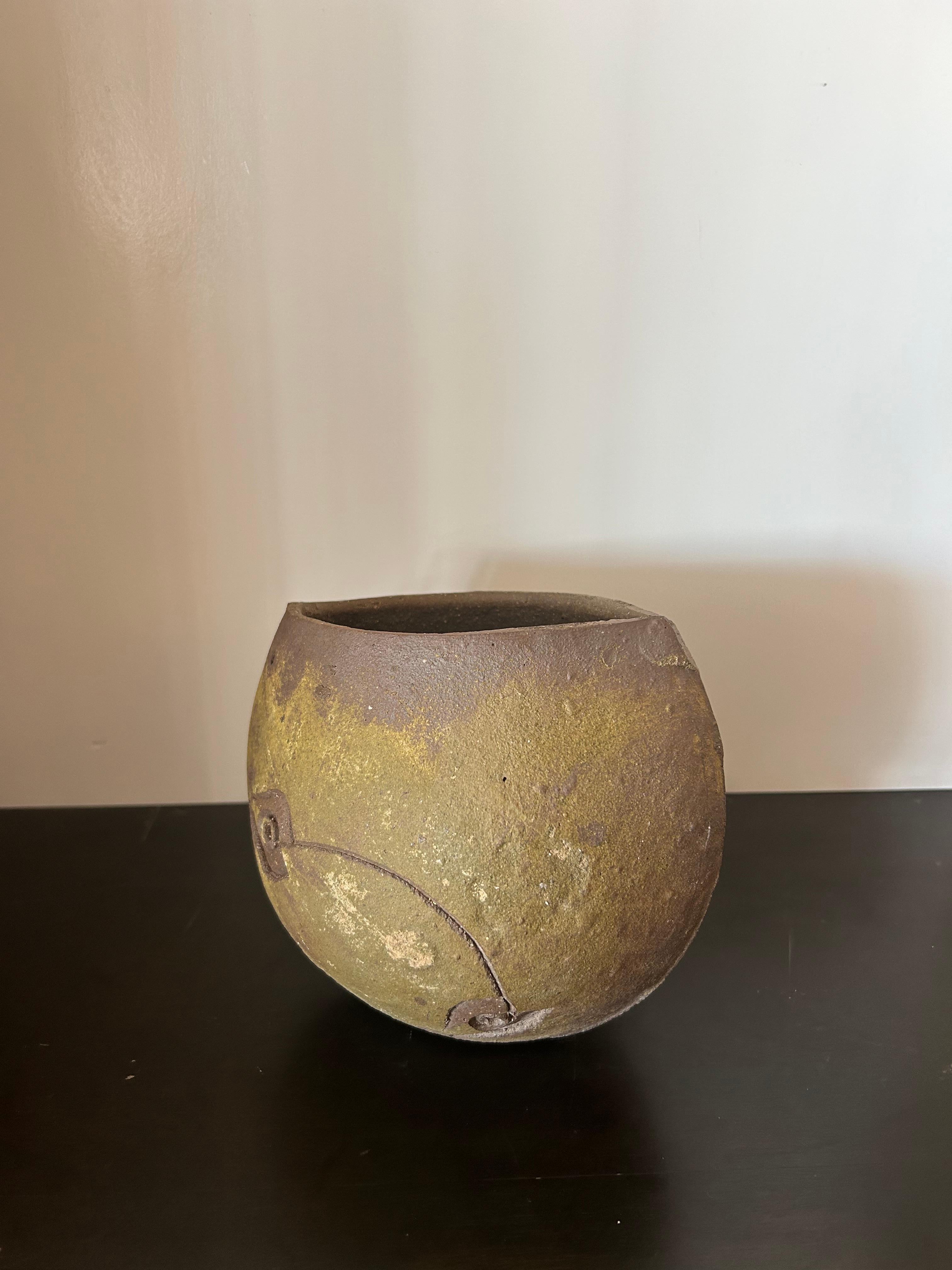 Earthenware pot by mid-century architect Paolo Soleri with minimal decorative fish motif. Can be displayed right side up or upside down..