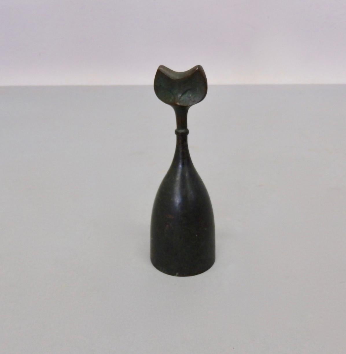 Nicely patinated bell with handle shaped after a feline head.